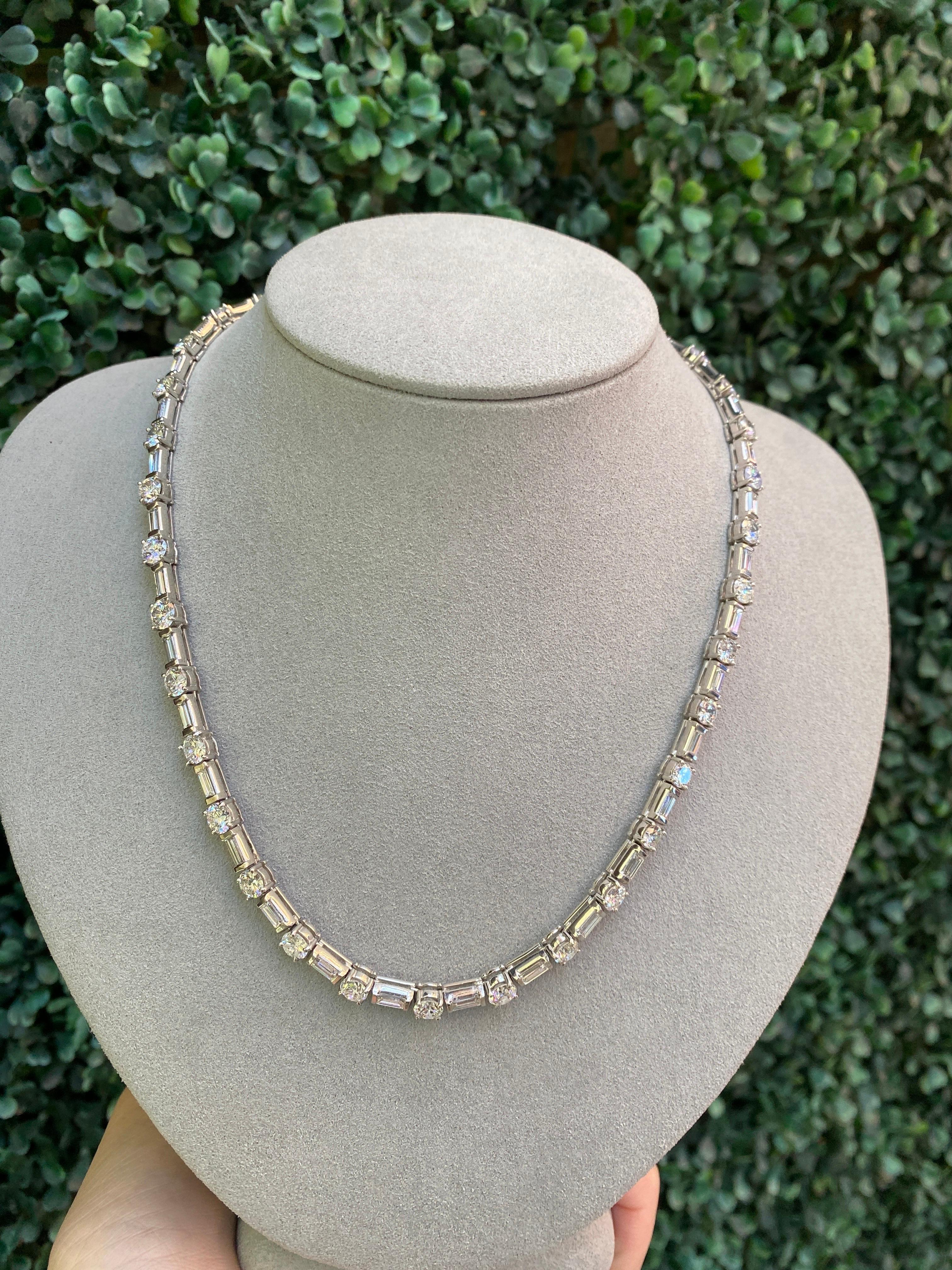 Elevate your jewelry collection with this exquisite tennis necklace featuring approximately 18.50ctw of natural round and baguette diamonds. Set in polished platinum, this piece exudes luxury and sophistication. The 16.75