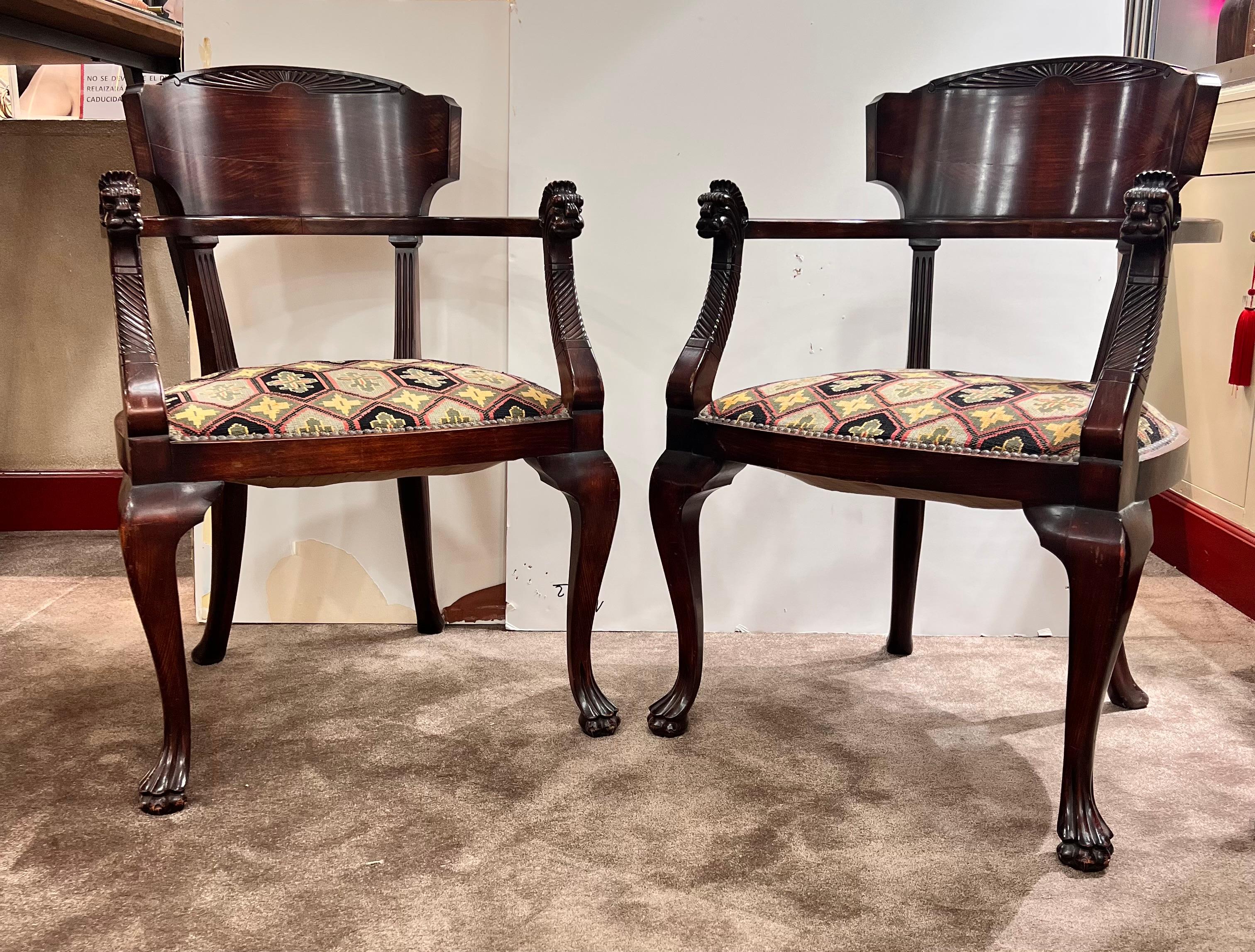 1850s European Empire Mahogany pair armchairs with Griffin God face and feet..

Upholstery with Osborne & Little with heraldic pattern in cross stich fabric. 
Dimensions Chair 
Height: 35,43 in. (90cm) 
Width: 23.62 in. (60cm) 
Depth: 20.07