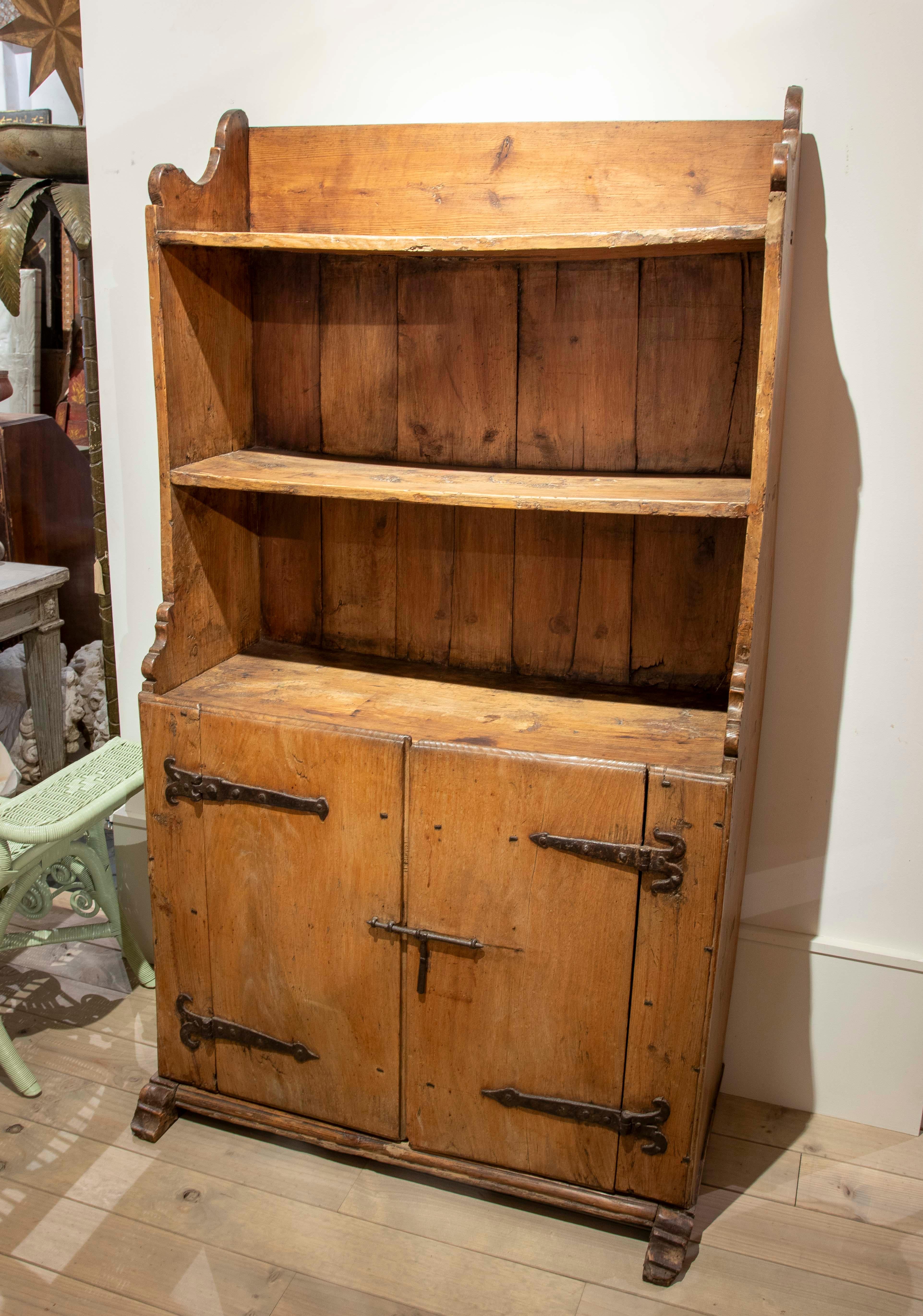 Une armoire rustique authentique en bois massif, idéale pour ajouter de la chaleur et du caractère à n'importe quel espace. Cette pièce d'inspiration traditionnelle comporte deux étagères supérieures ouvertes et une base fermée par deux portes avec