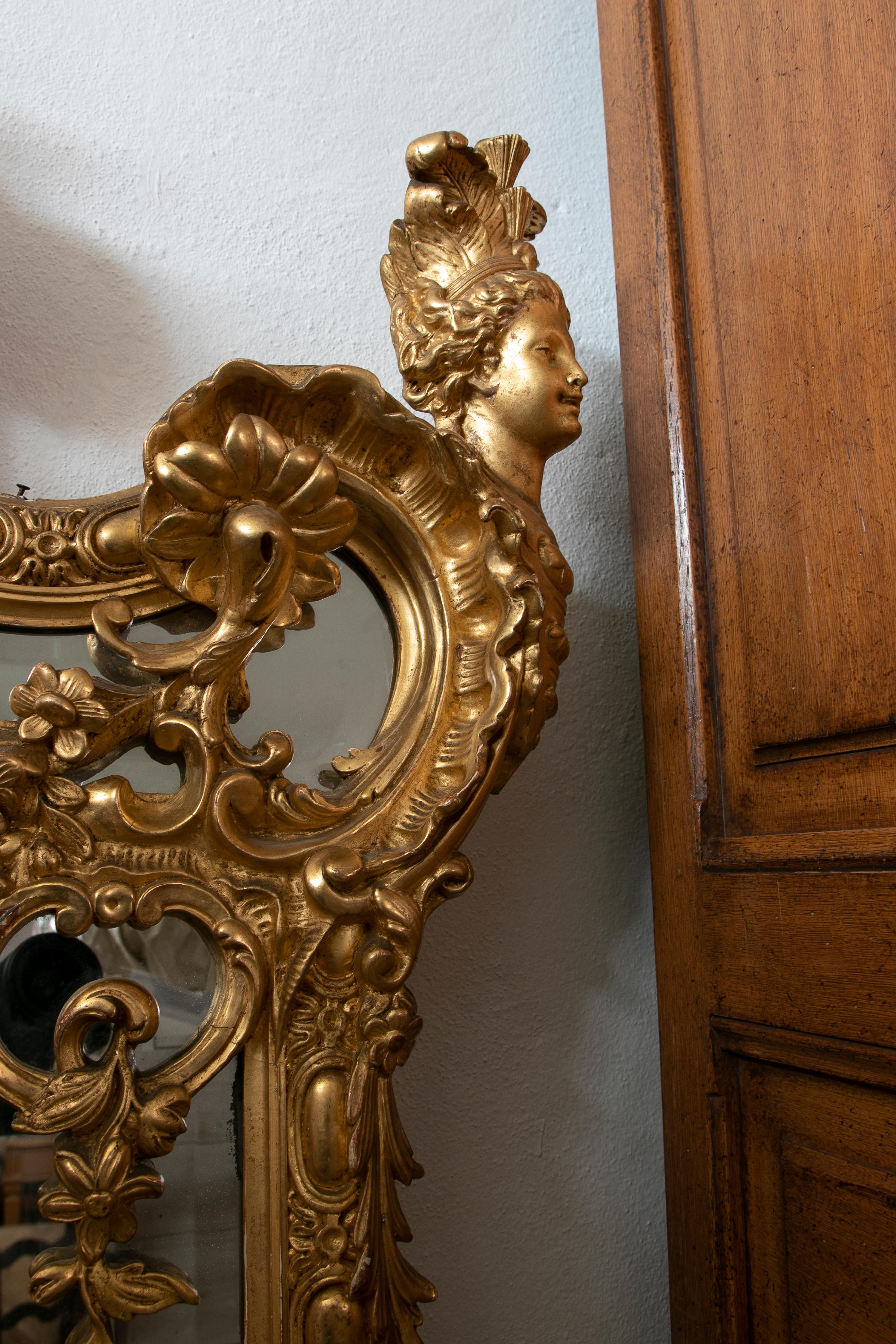 1850s French gold giltwood wall mirror with acanthus leaf scrolls decoration.