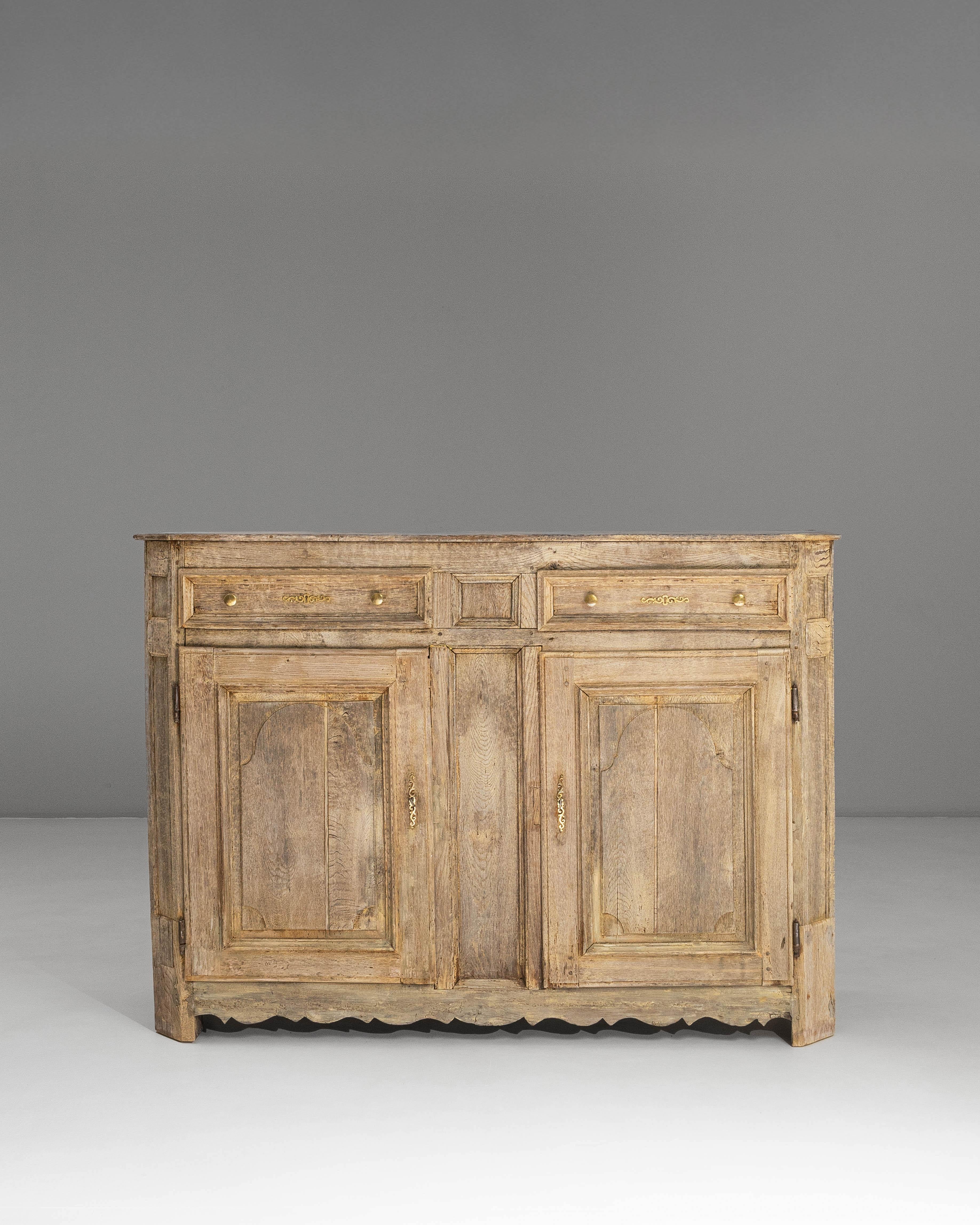 This 1850s French Provincial oak buffet showcases the warm, timeworn character that defines countryside craftsmanship of the era. Built from solid oak and preserved in its original patina, the piece features a harmonious arrangement of four upper