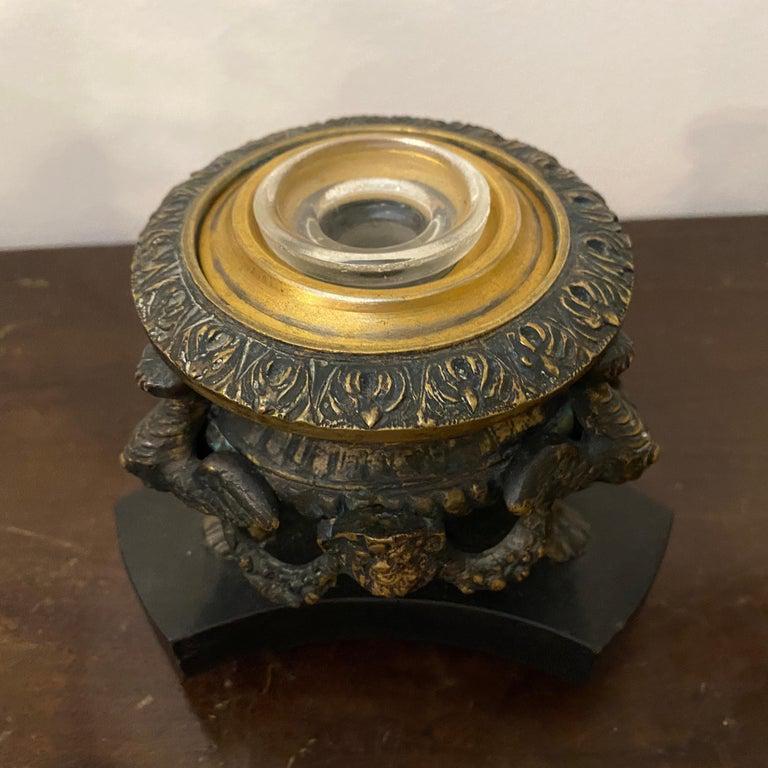 A bronze inkwell surmounted by a faun manufactured in Italy in the mid-18th century.