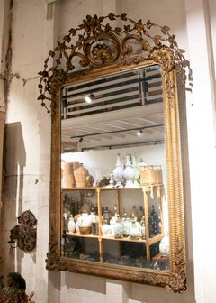 1850s Louis XVI Style Antique Gilt Mirror with Carved Floral Crest