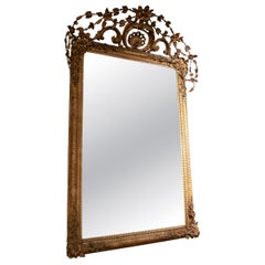 1850s Louis XVI Style Antique Gilt Mirror with Carved Floral Crest
