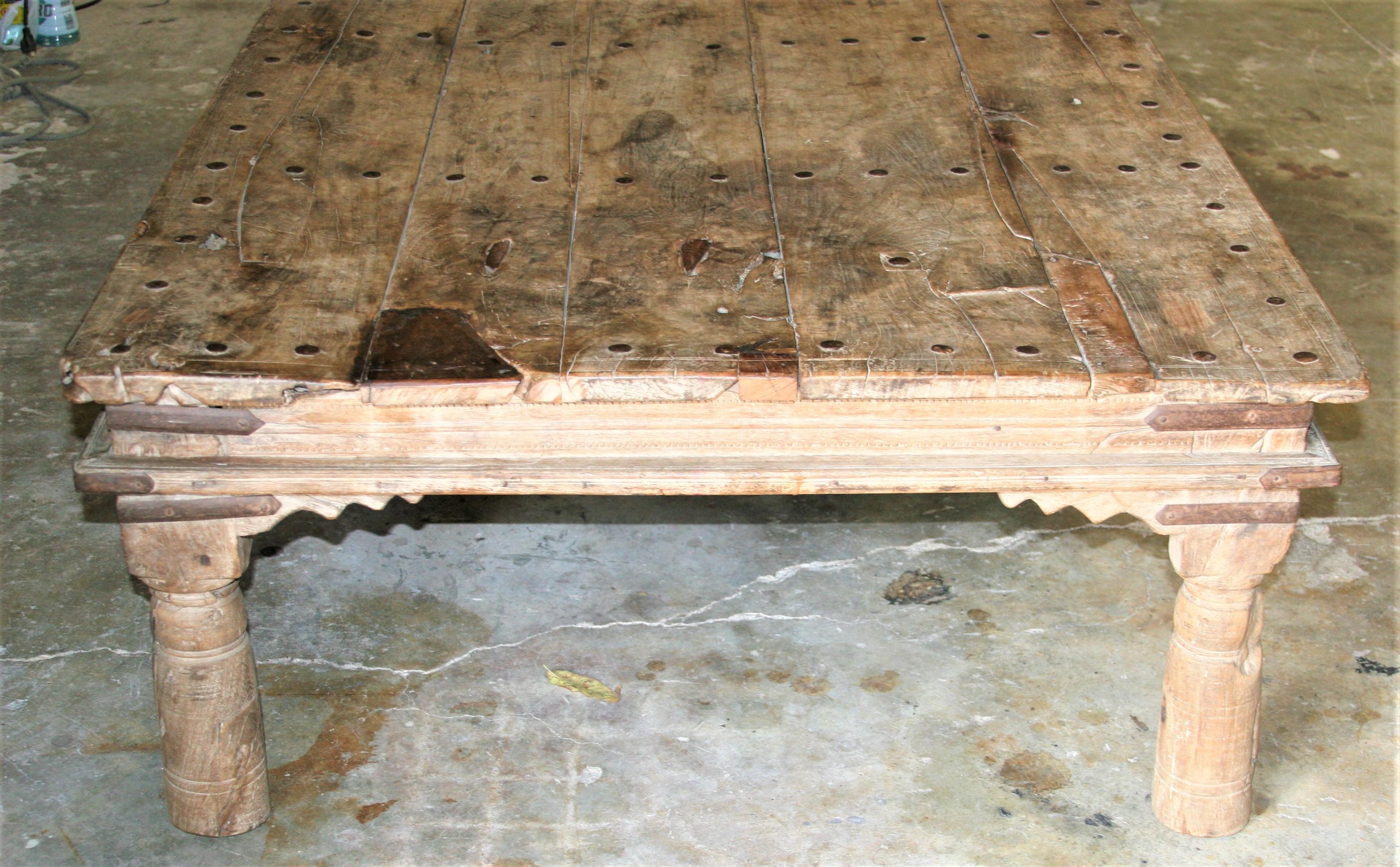 A rustic chic. This large teak wood coffee table was used in the corridors of sprawling colonial homes and was constantly exposed to the elements.
This is an authentic original without being restored. A glance at the images will show how this table