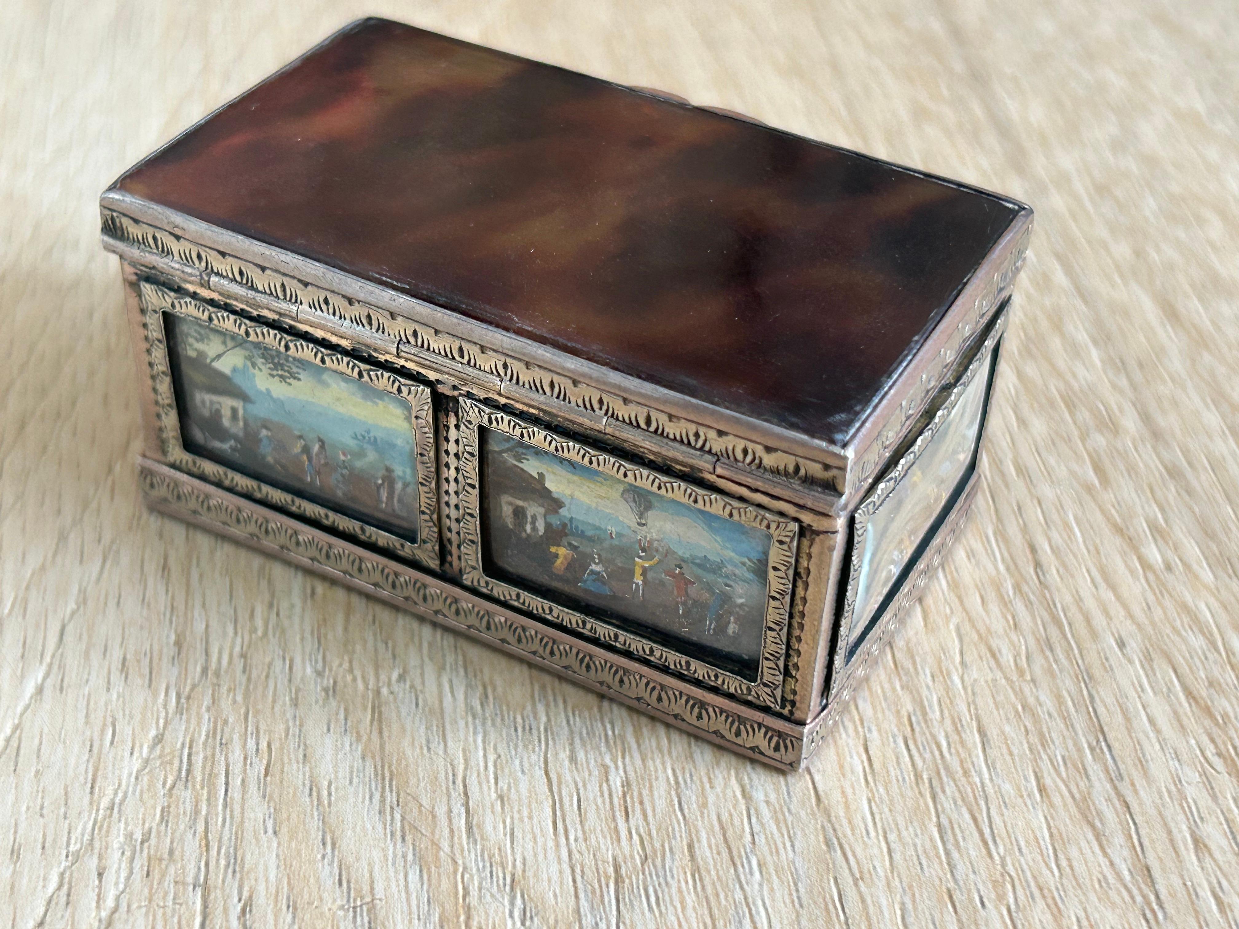Small Silver and Tortoiseshell jewellery box, with the top of the lid and the bottom of the box being tortoiseshell. The edges of the box is in gold plate and depict on the sides, small painting of colonial inspiration, two small painting on the