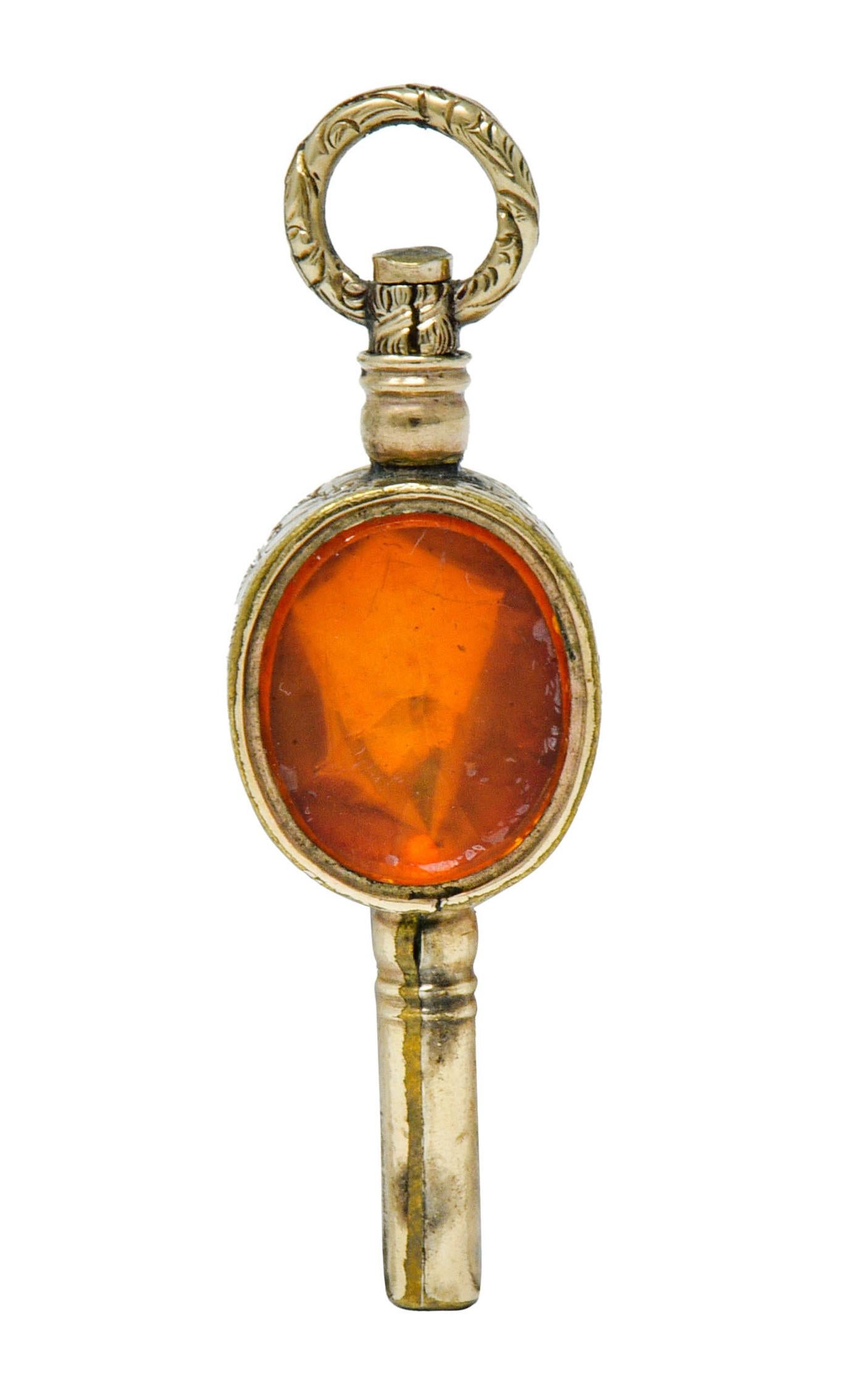 Pendant charm is a fob inspired watch key designed as a cylindrical tube centering an oval form that rotates

Oval form is bezel set on both sides featuring an oval cut foil backed citrine and an oval bloodstone tablet

Citrine transparent and a