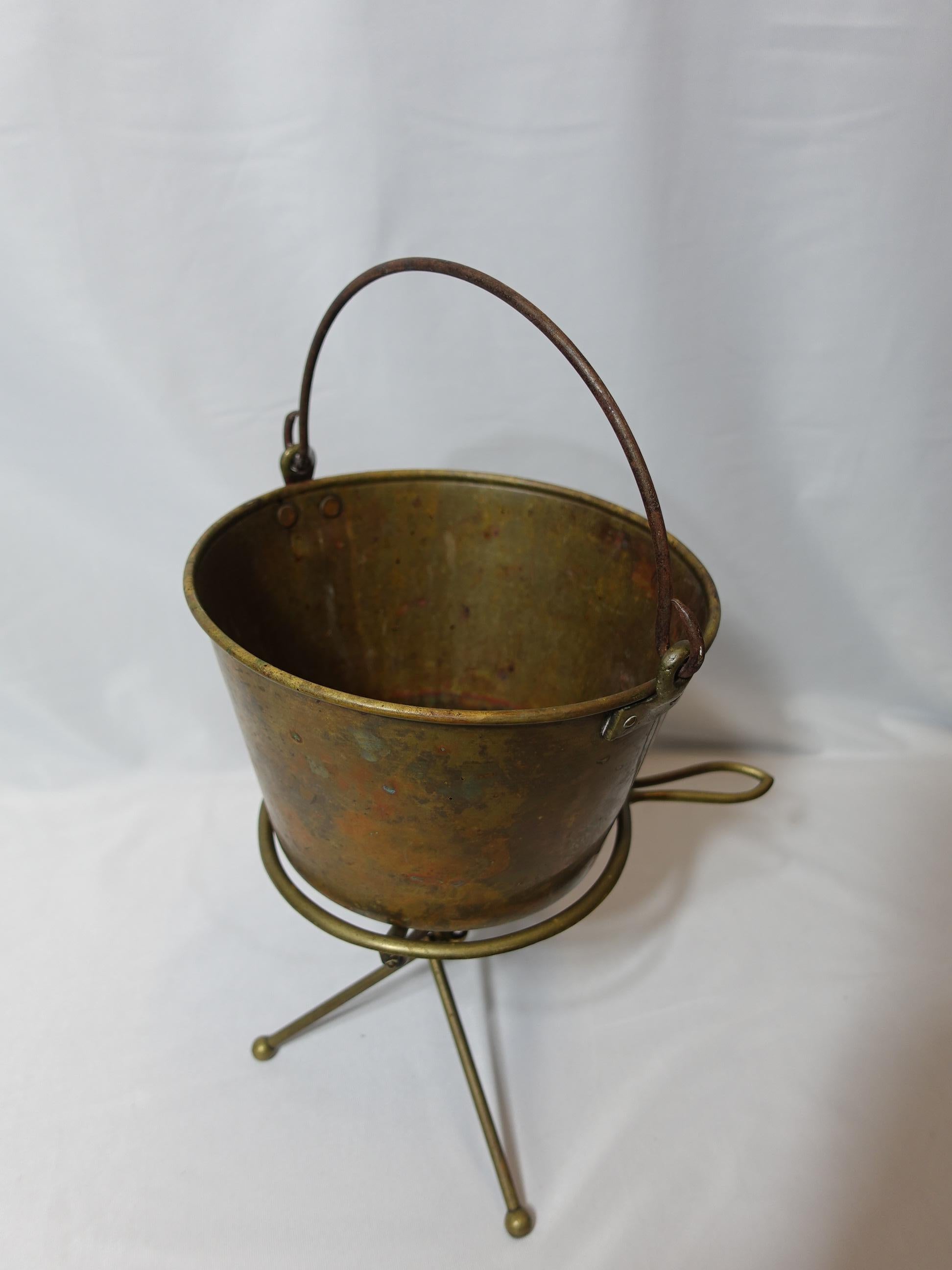 An 1851 Dec. 16, Hayden Pat. Ansonia Brass Co. Bail brass fireplace bucket or planter marked on the bottom and a Brass Reivet Stand.
The Bucket is 19