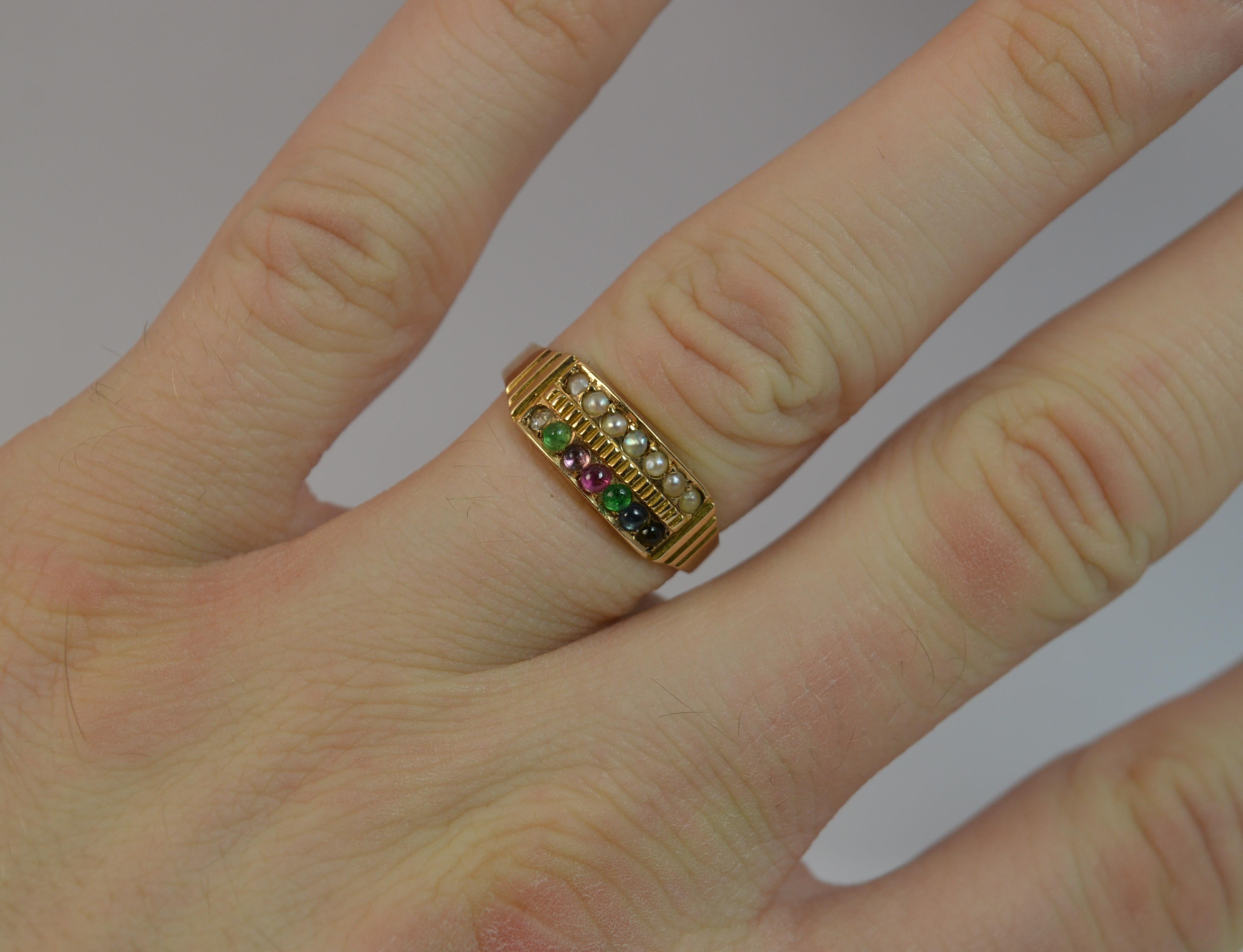 A very rare ladies Victorian period ' DEAREST ' design cluster stack ring.
SIZE ; N UK, 6 3/4 US
Set with Diamond, Emerald, Amethyst paste, Ruby, Emerald, Sapphire and Topaz to one half and seed pearls set above in a full row.

13mm spread of
