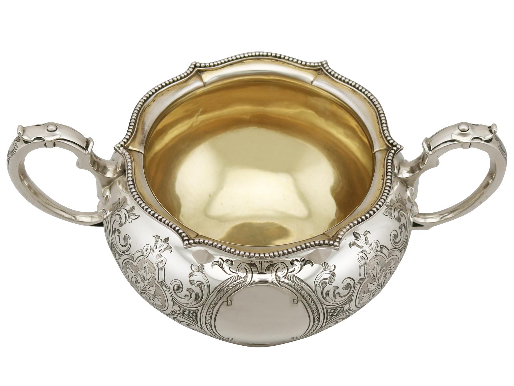 An exceptional, fine and impressive antique Victorian English sterling silver sugar bowl; an addition to our silver teaware collection.

This exceptional Victorian silver sugar bowl, in sterling standard, has a circular rounded form.

The body