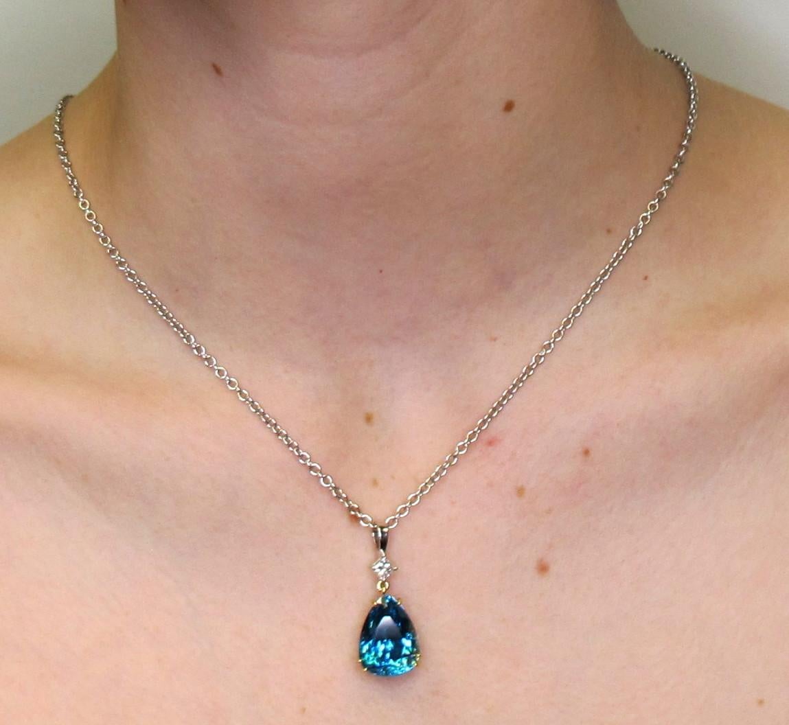 A vivid 18.57 carat pear shaped blue zircon sits center stage in this 18k white gold pendant. The stunning gem is the color of 