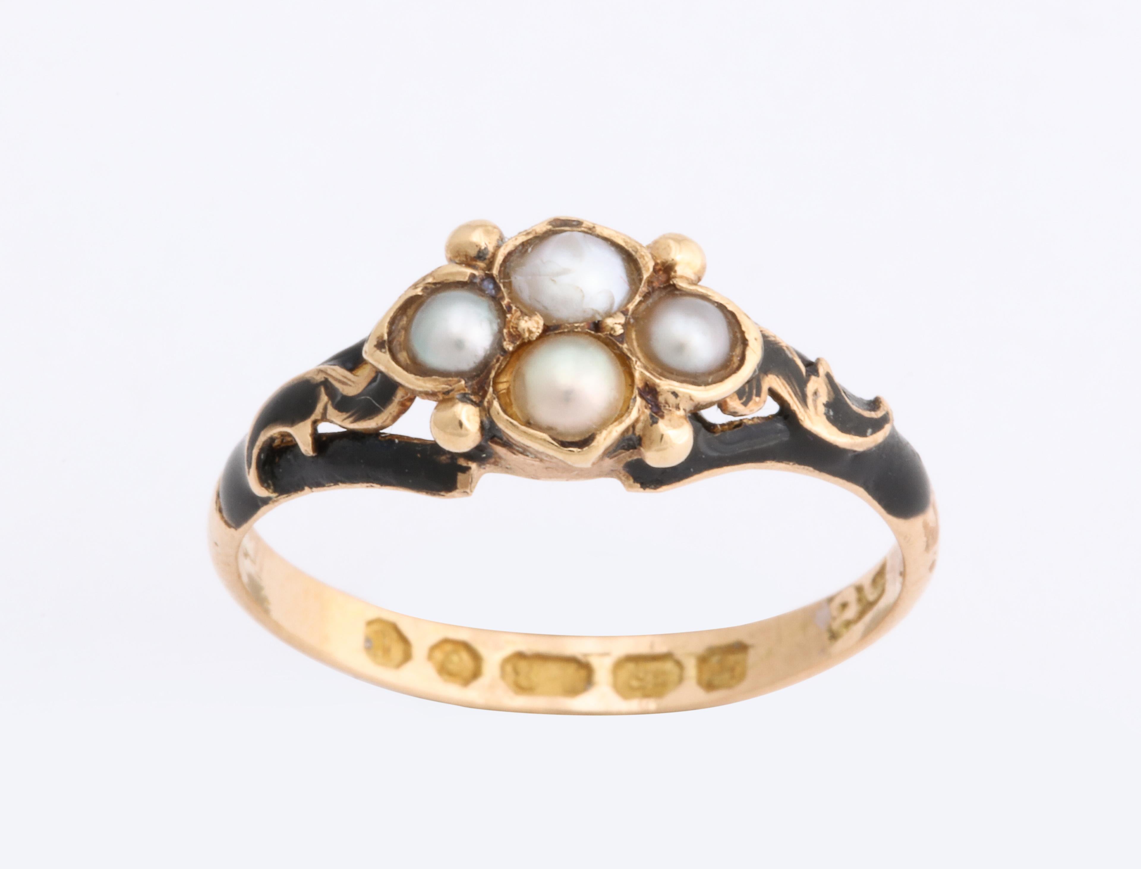 Designed as a forget me not pearl cluster surrounded by black enamel enhanced with gold scrolls, the reverse fitted with hair compartment, mounted in 18k gold.

Fully hallmarked for London 1858 on inside of shank

Size 6

Mourning rings were made