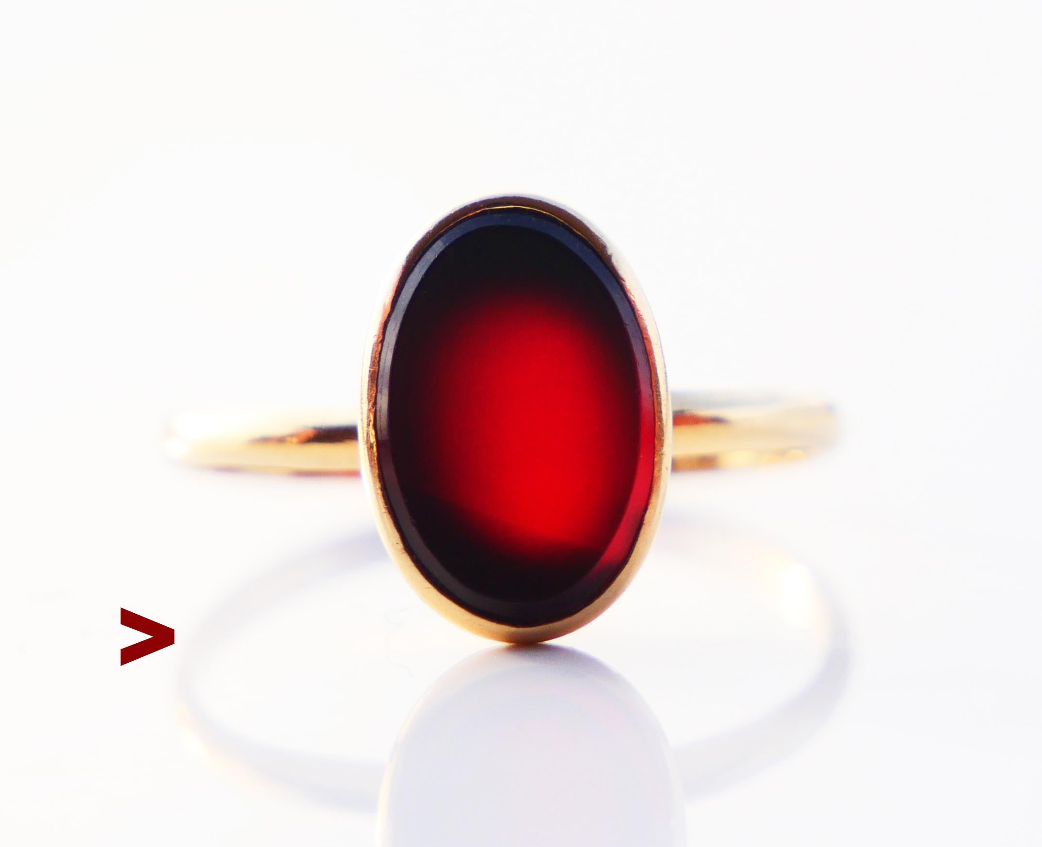 Signet Ring with plain band adorned with bezel set polished plate of natural Red Onyx stone 9 mm x 6 mm x 3 mm deep / ca 3 ct. Stone may change color a bit under from dark Red to almost Black under different light. Crown is 4 mm deep.

Stone's