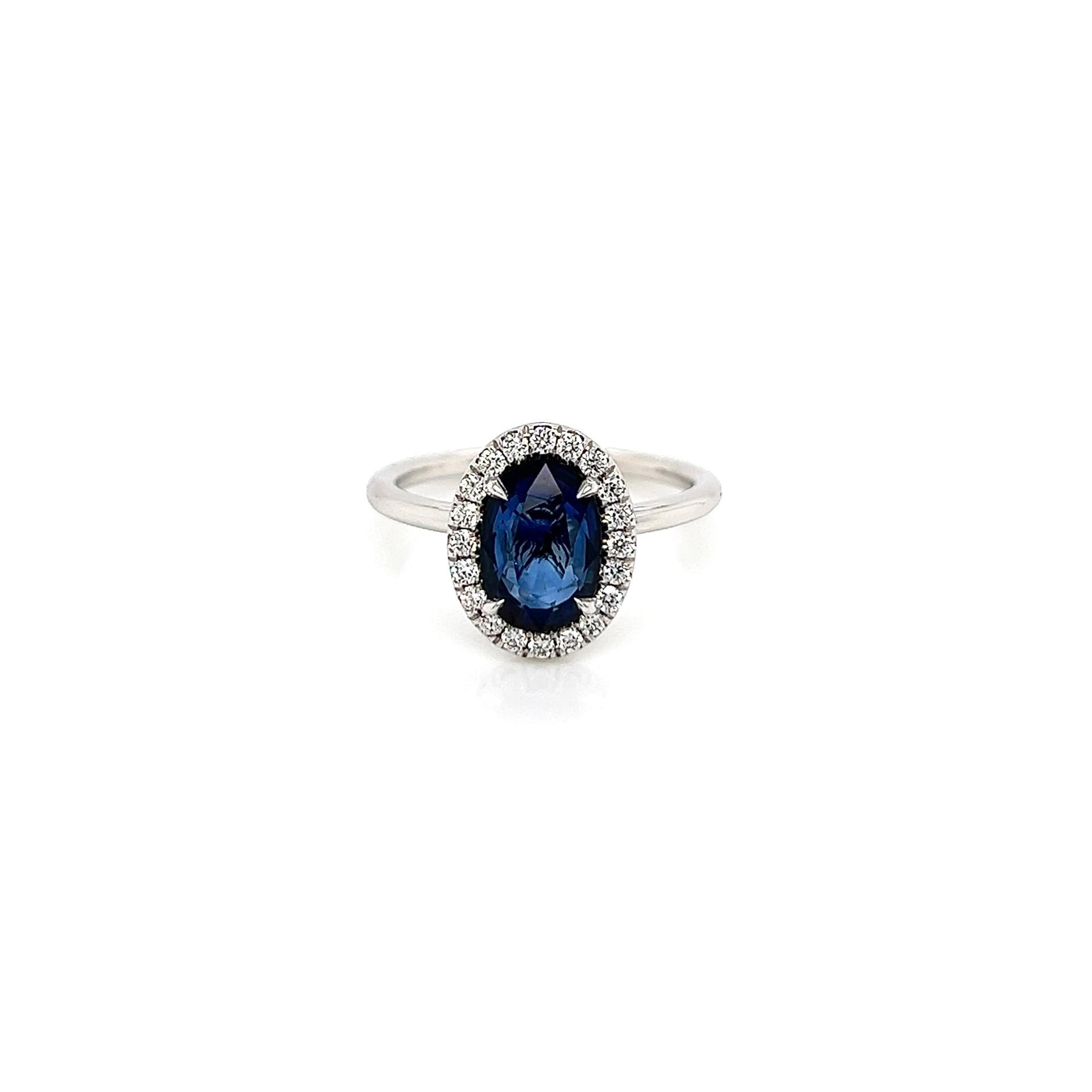2.15 Total Carat Sapphire Diamond Ladies Ring

-Metal Type: 18K White Gold
-1.85 Carat Oval Shaped Blue Sapphire
-0.30 Carat Round Side Diamonds 
-Size 6.0

Made in New York City.