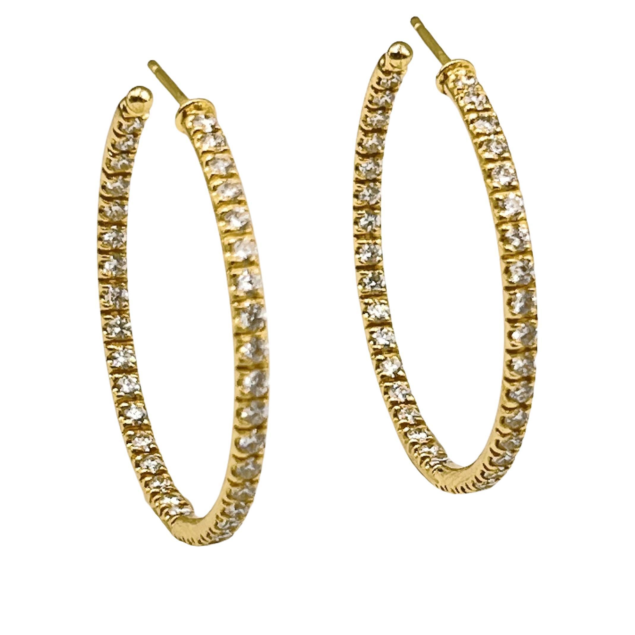 18kt yellow gold polished hoop earrings with diamonds set to the front on the outside and inside of the hoop.  Seventy-four round brilliant-cut diamonds weighing approximately 1.85 total carats (G-H color and VS1-VS2 clarity).  Pierced posts with