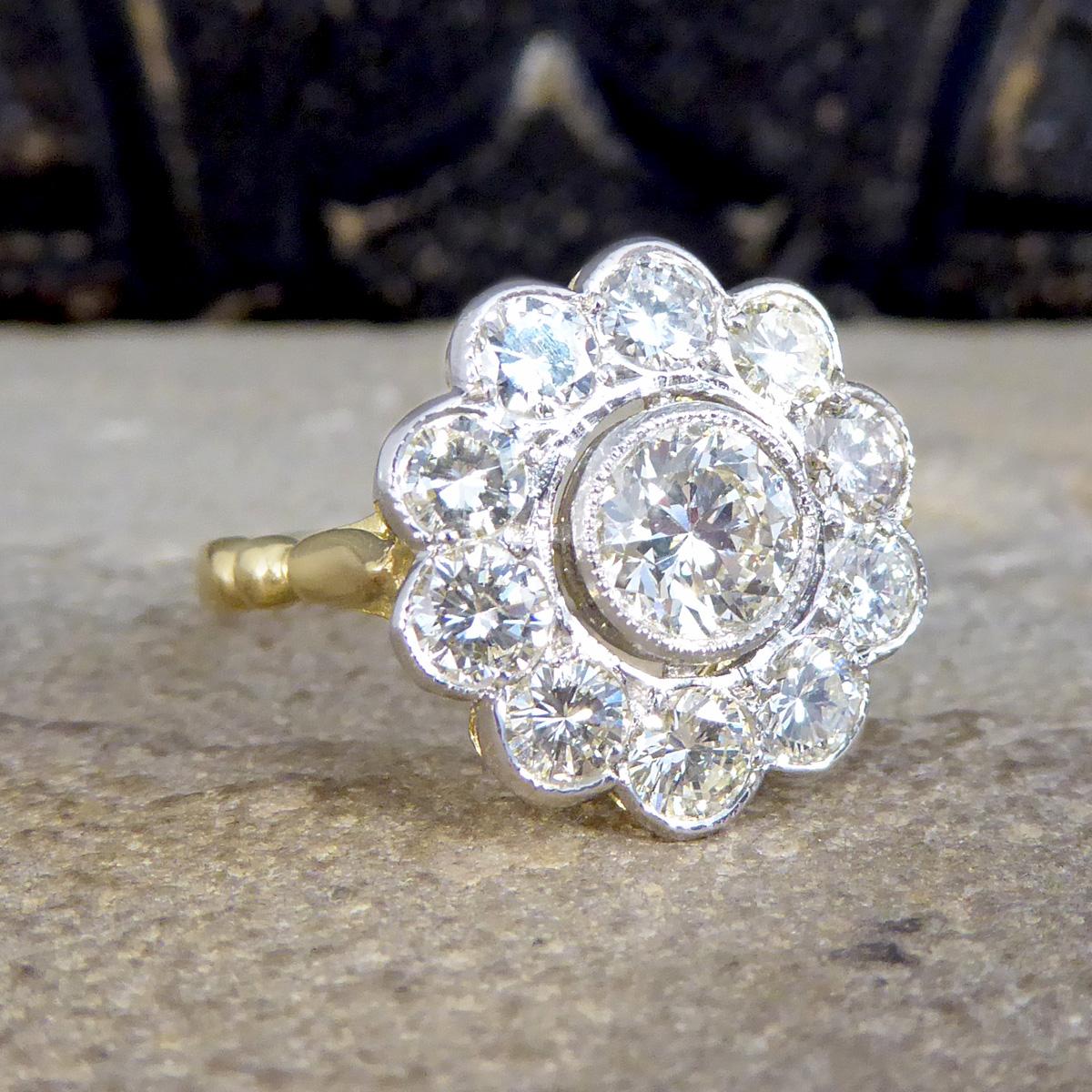 Such a stunning contemporary Daisy cluster ring has been made to resemble a 1920's style ring. It is set with Round Brilliant cut Diamonds giving it a total carat weight of 1.85ct with the centre being the largest with 8 surrounding stones with a