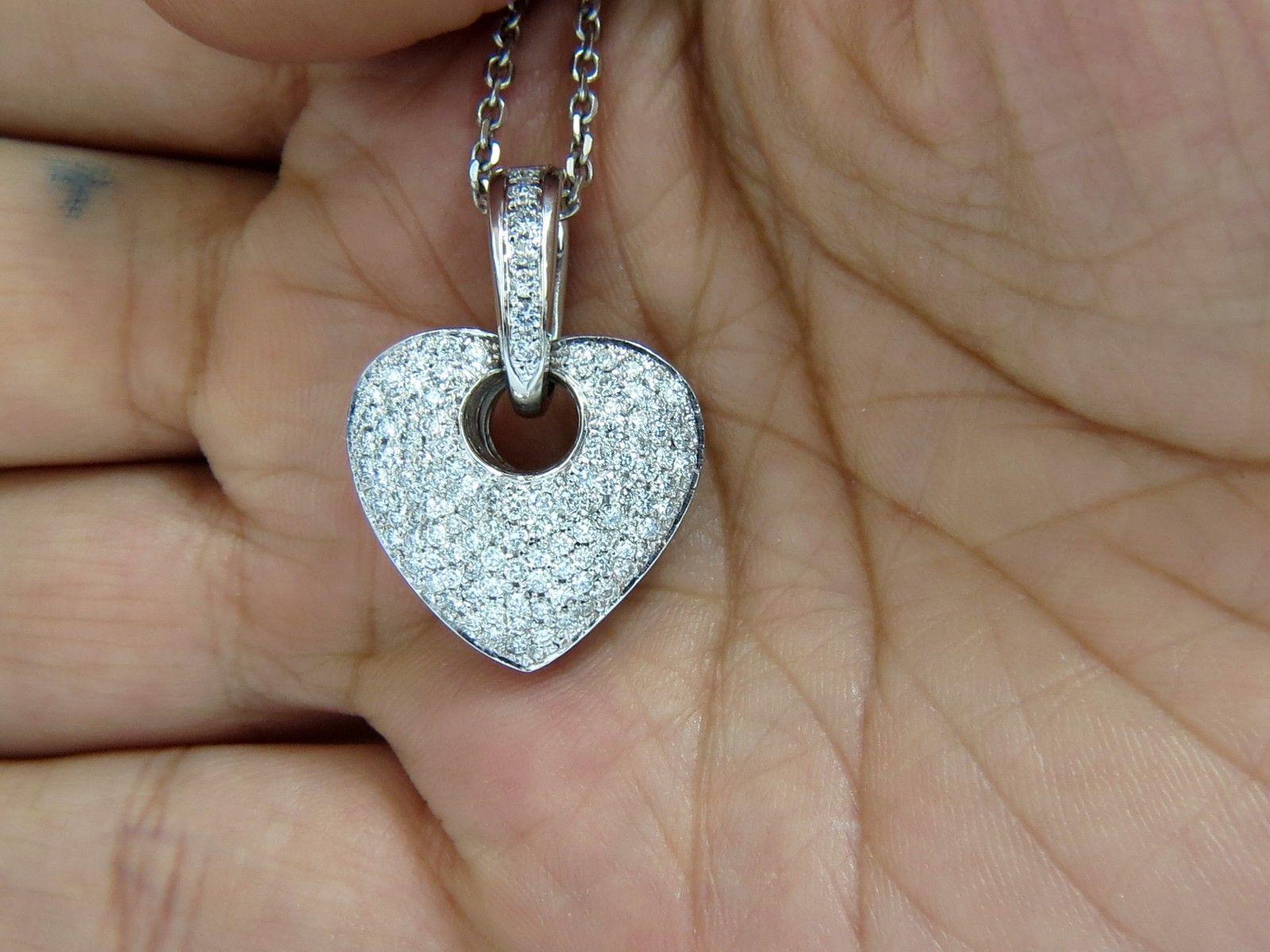 Modified heart design

Dangles on Bale.

Excellent diamonds bead set.

1.85ct.

F/G color, Vs-2 clarity

14kt. white gold

& 

14kt white gold necklace

pendant measures:

26mm long (with bell)

20mm wide

16 inches necklace

$6000 appraisal to