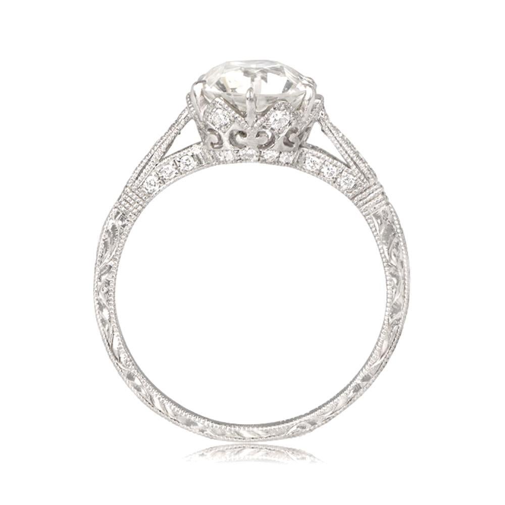This diamond solitaire engagement ring has an old European cut diamond set in prongs, weighing 1.85 carats with L color and VS2 clarity. The ring also has approximately 0.32 carats of additional diamonds set on the shoulders and under-gallery.