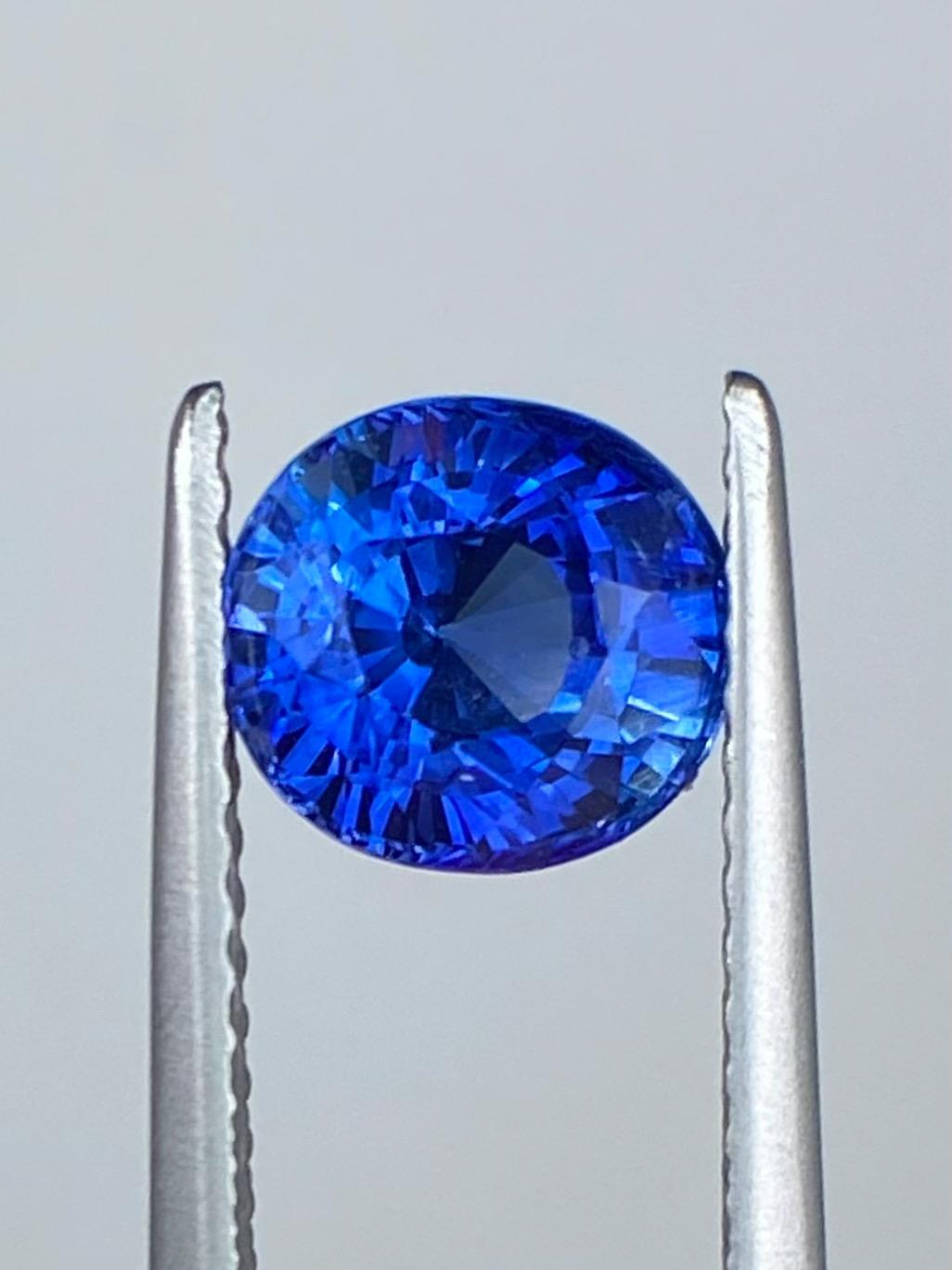 The Sapphire Merchant proudly presents this 1.85ct Natural Vivid Blue Sapphire. Expertly faceted in an elegant oval shape, this stunning jewel boasts a Munsell Color Grade of 5PB 4T 14S (considered the highest grade of colour), which showcases its