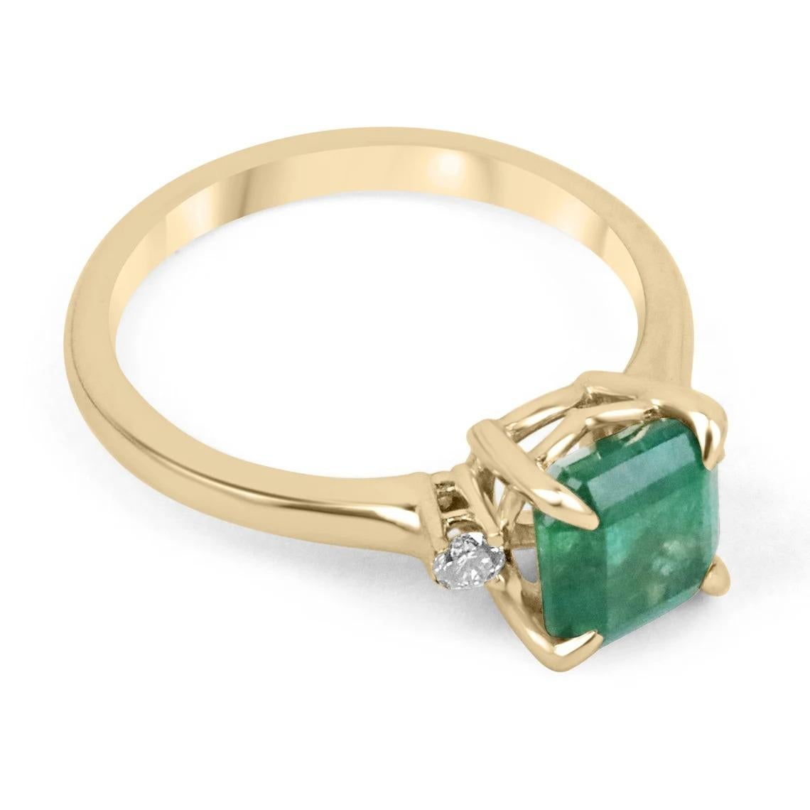 A classic emerald and diamond engagement, statement, or right-hand ring. Dexterously crafted in gleaming 14K yellow gold this ring features a 1.76-carat natural Zambian emerald-Asscher cut. Set in a secure prong setting, this extraordinary emerald