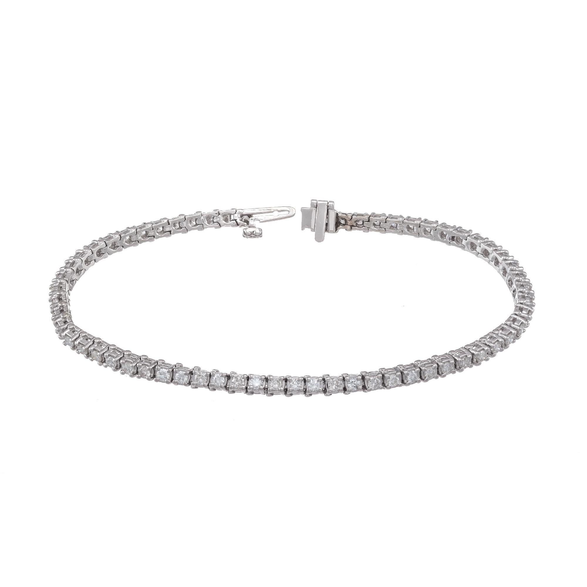 1.86 carat tennis bracelet in 14k white gold with hidden catch and underside safety 

62 round brilliant cut diamonds H-I SI-I, approx. 1.86ct
14k white gold 
Stamped: 14k
9.4 grams
Bracelet: 7 Inches
Total length: 7 Inches
Width: