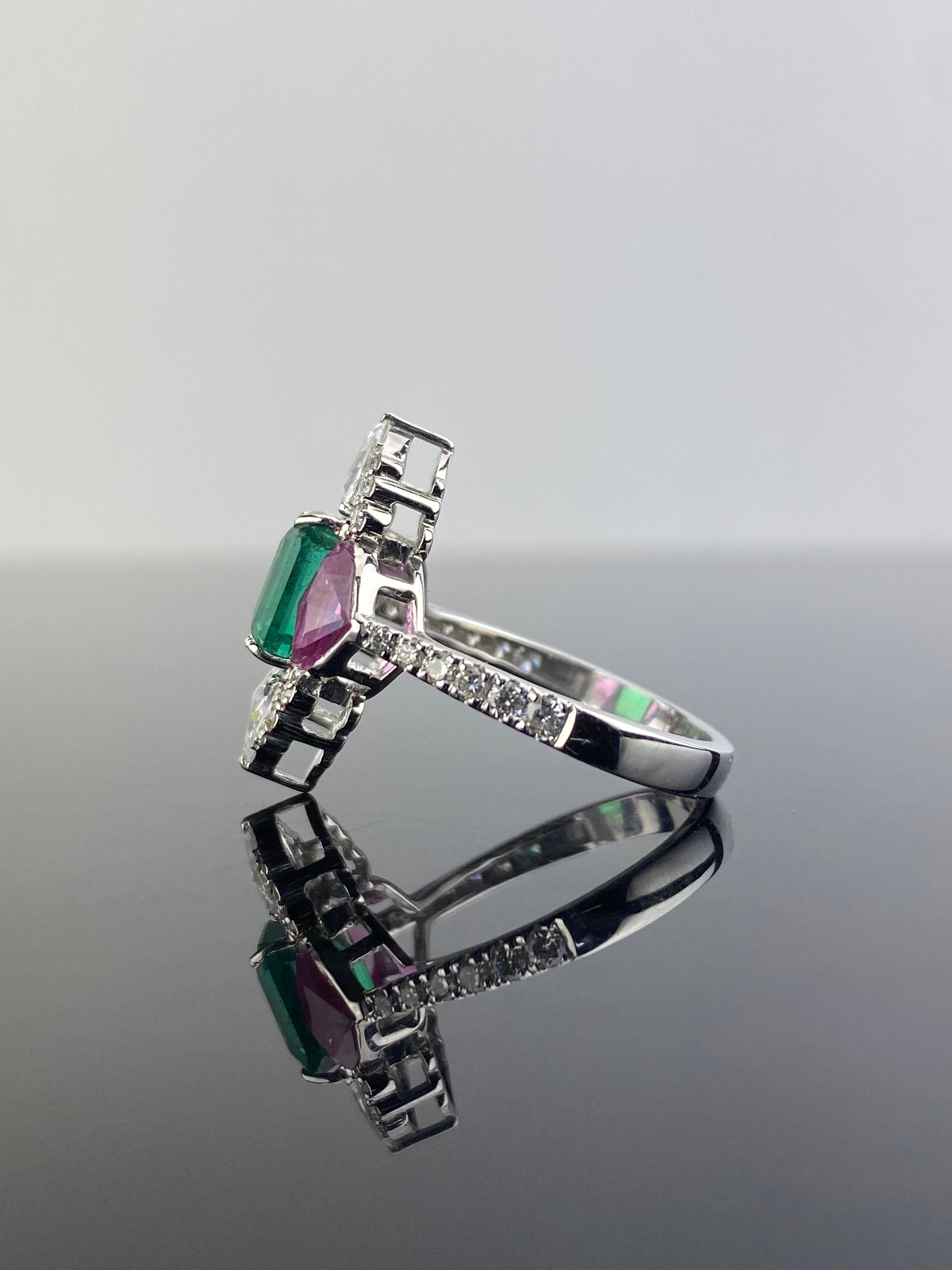 A stunning art-deco vibe, 1.86 carat Zambian Emerald center stone with 2 custom cut Pink Sapphire side stones and White Diamond engagement ring, set in solid 18K White Gold. The ring is currently sized at US 6, can be resized. The Emerald is