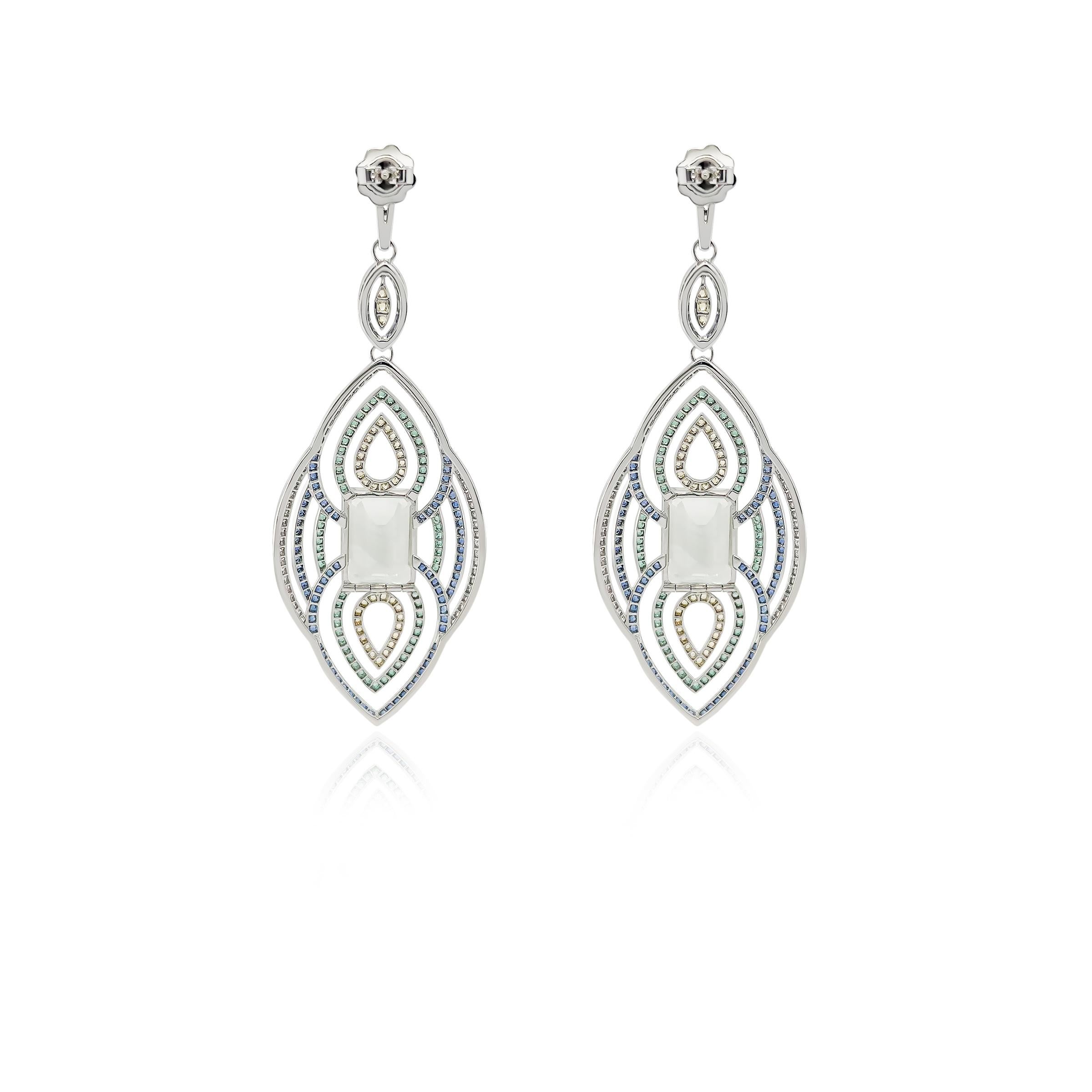 A statement pair of earrings crafted with precision and passion, these earrings feature mesmerizing green amethyst as the center stone surrounded by a design incorporating colored sapphires and peridot, each radiating a unique hue of elegance. Set