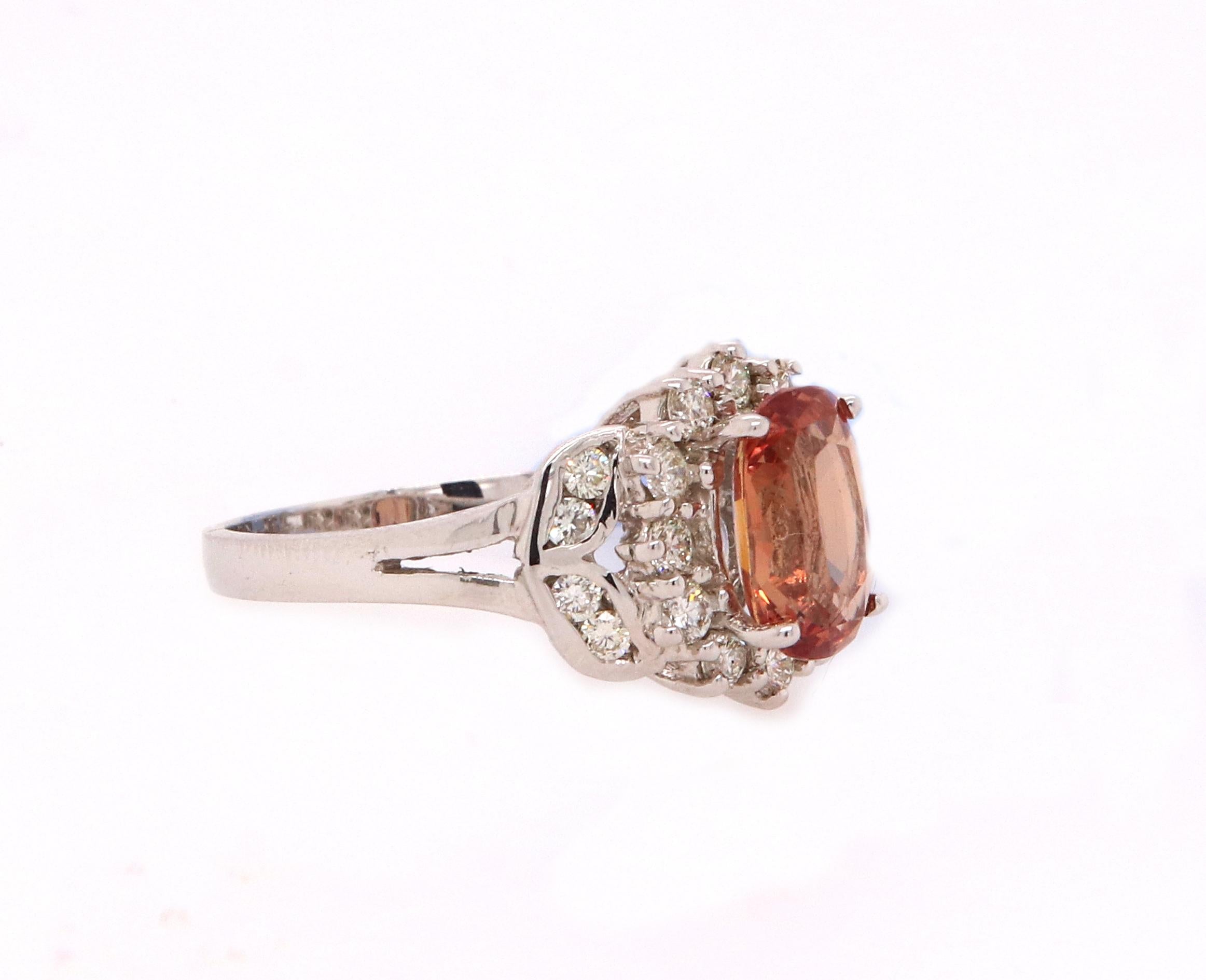 Material: 18K White Gold 
Center Stone Details: 1 Cushion Cut Padparadscha Sapphire at 1.86 Carats - Measuring at 8.49 x 5.65 x 3.81 mm
Diamond Details: 20 Brilliant Round White Diamonds at 0.46 Carats- Clarity: SI  / Color: H-I
Complimentary sizing
