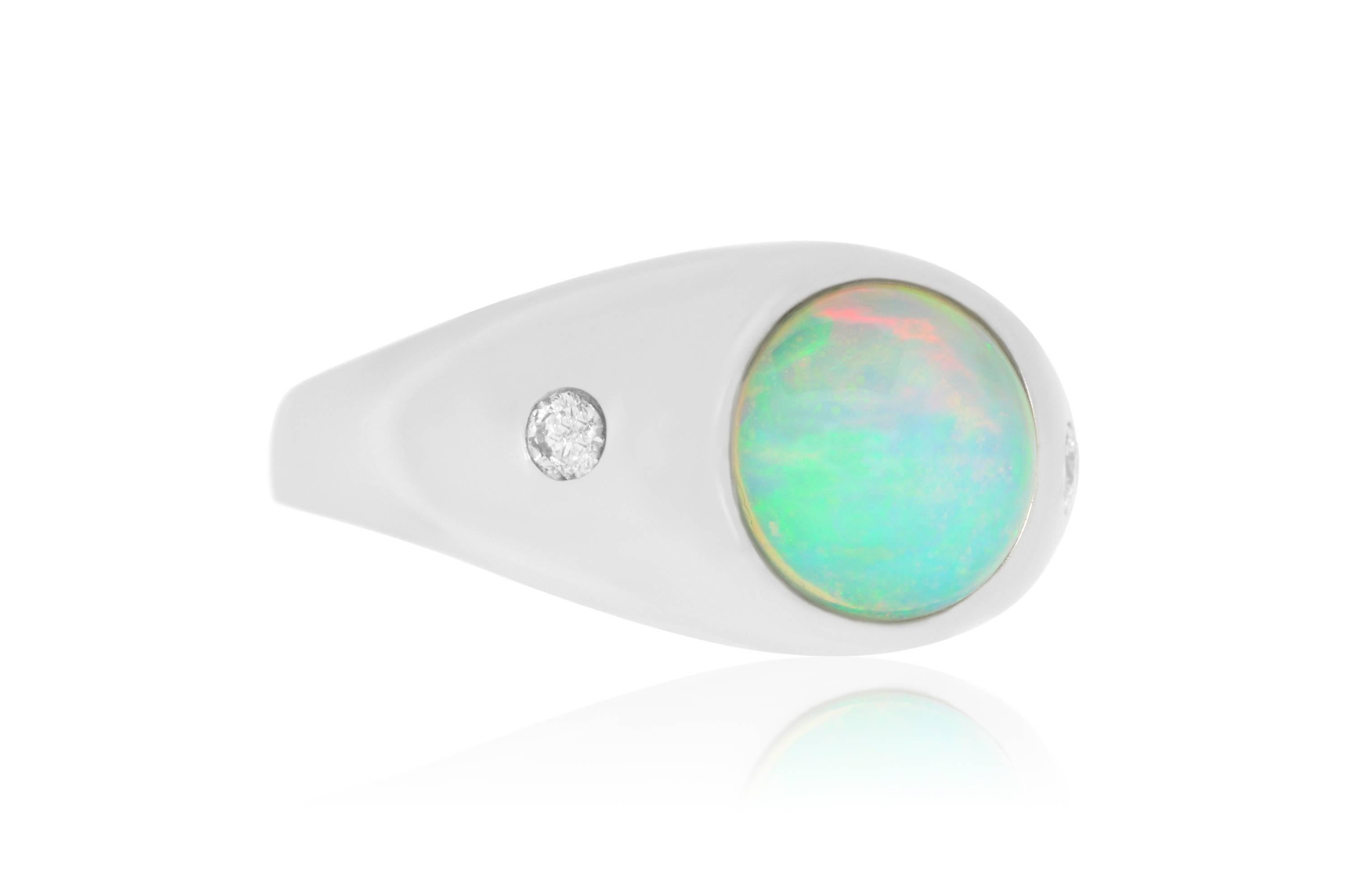 This unique round cut 1.86 carat Opal is set in a 14k White Gold with 2 accent white diamonds.   This sleek modern setting accentuates the alluring opal.

Material: 14k White Gold
Colored Diamond:: 1 Round Cut Opal at 1.86 carats.
Diamonds: 2 Round