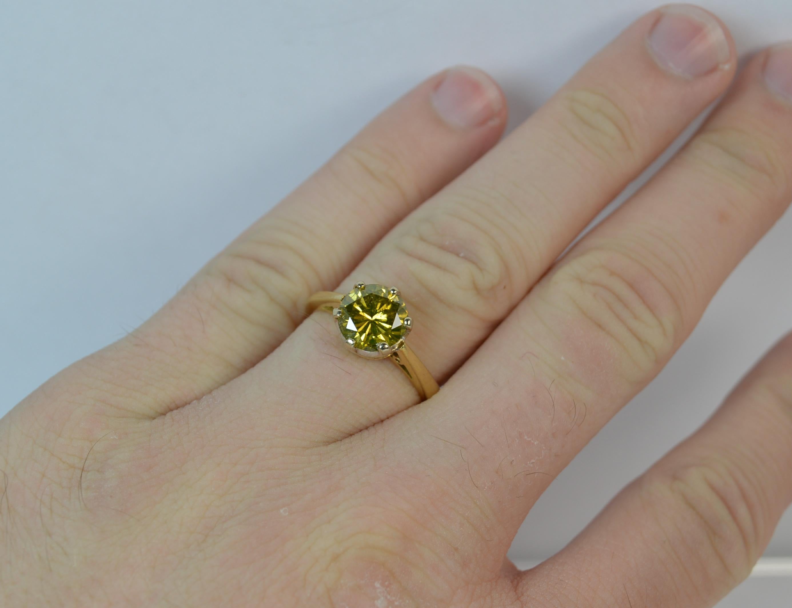 

A large and natural Diamond and 18ct Gold ring.

The single stone yellow diamond to measure 7.8mm in diameter and weigh 1.86 carats as confirmed to the shank. Mounted into a six claw setting. Protruding 6.8mm off the finger.

A natural round