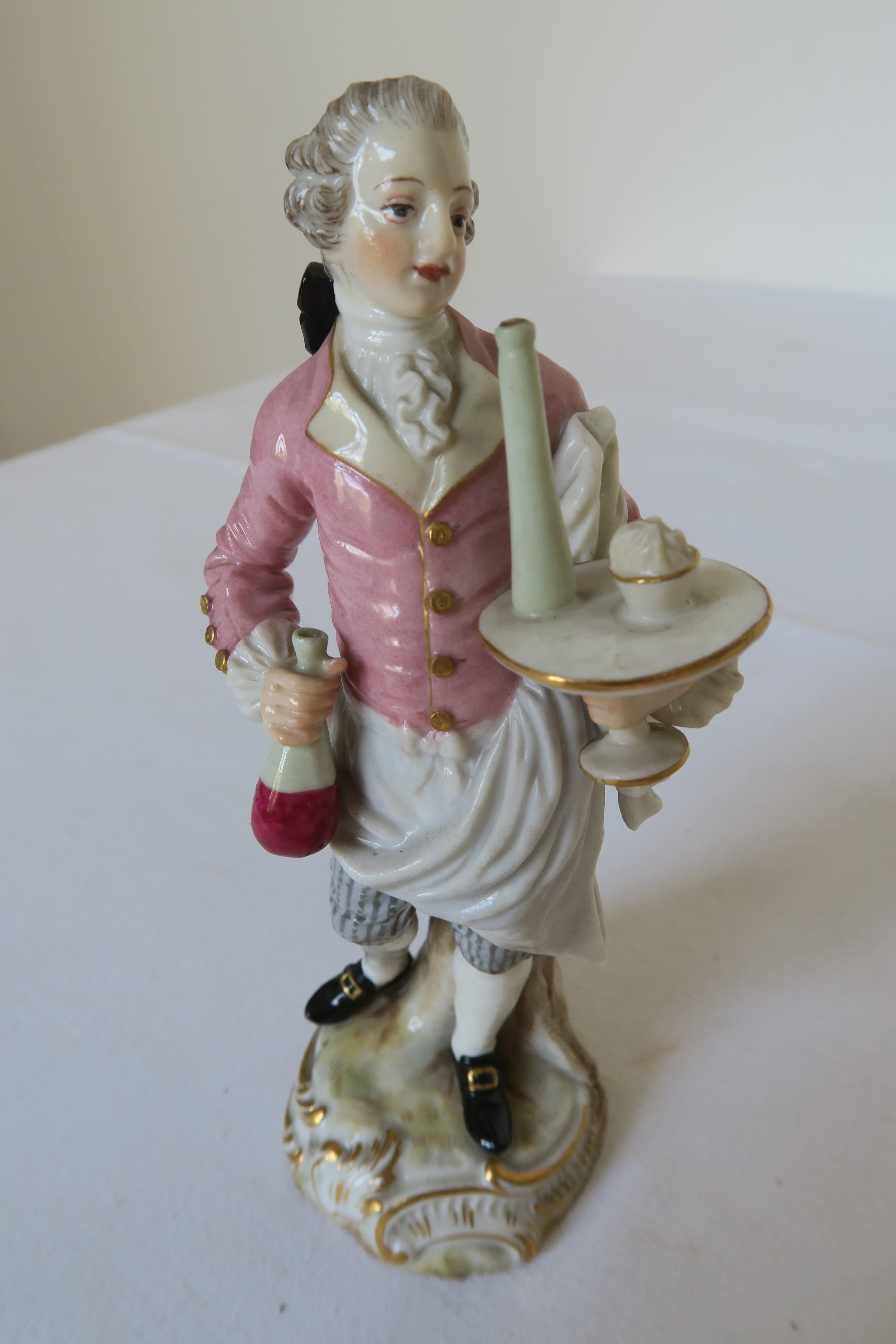 For sale in this ad you can find the prettiest little porcelain figurine. It was manufactured by Meissen Porcelain in the 1860s. The figurine depicts a water carrying a tray with food and drink. He looks brisk and happy to serve. The figurine was