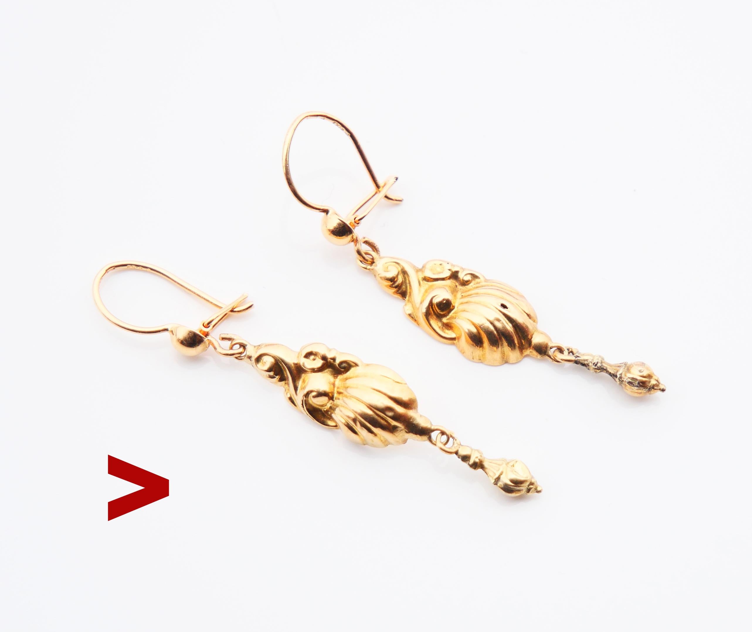 
A pair of antique fancy carved hollow dangles in solid 18K Yellow Gold with freely suspended tassel-shaped dangles.

Swedish hallmarks on both marked 18K Gold.

Maker's hallmarks are barely visible/worn. Date marks F5 = made in 1860.

Each earring