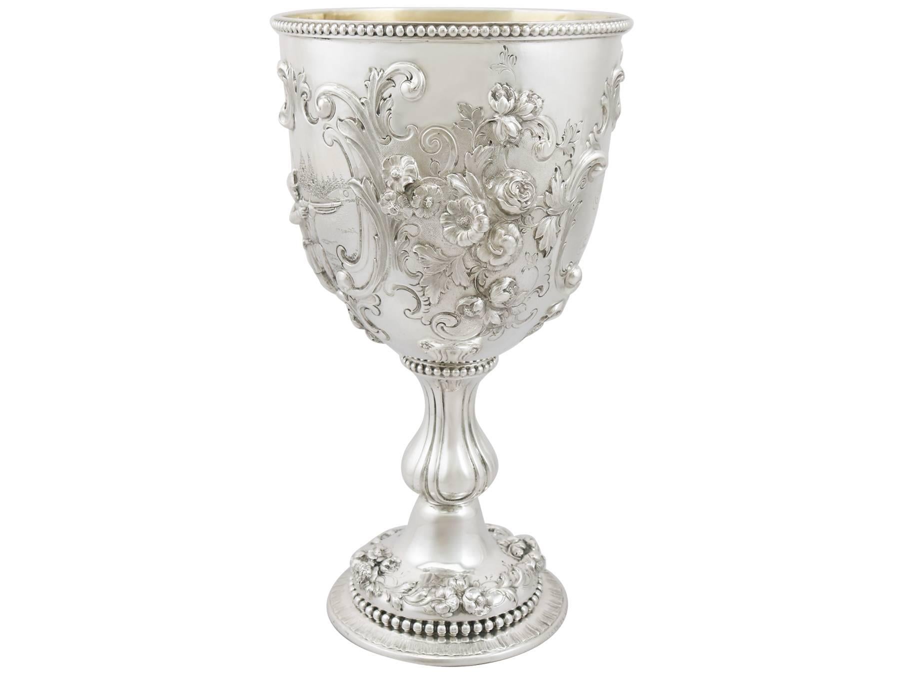 A magnificent, fine and impressive, large antique Victorian English sterling silver presentation cup; an addition to our presentation silverware collection.

This magnificent antique sterling silver cup has a circular bell shaped form to a bulbous