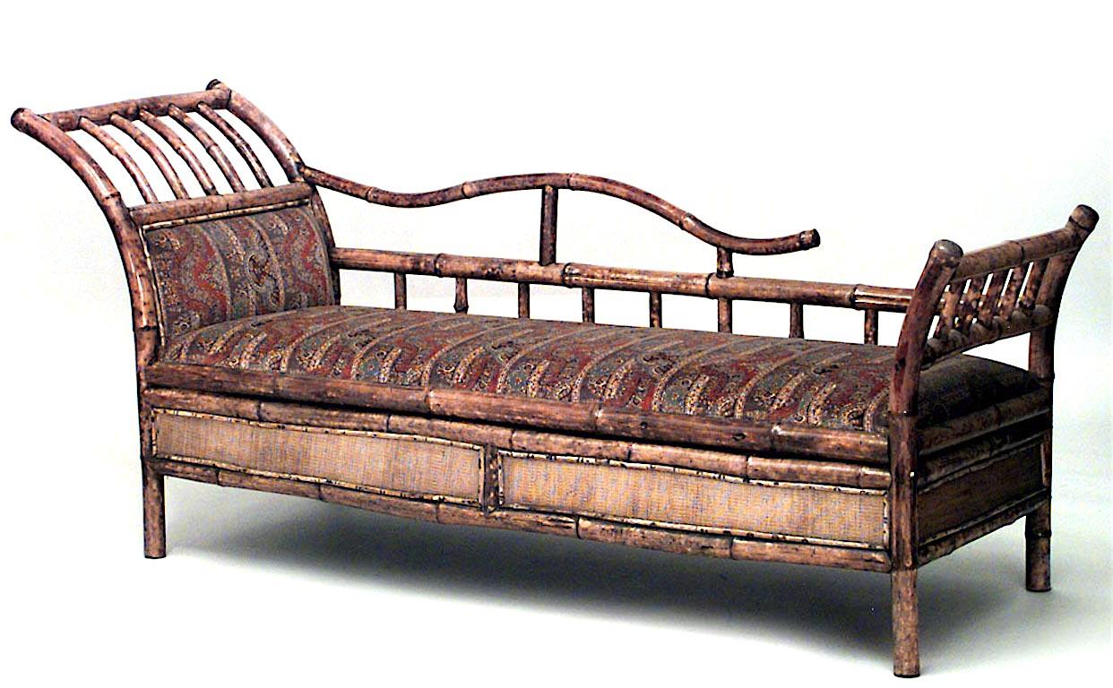 English Victorian Bamboo r√©camier with rush apron and open design spindle arm and paisley upholstery.
