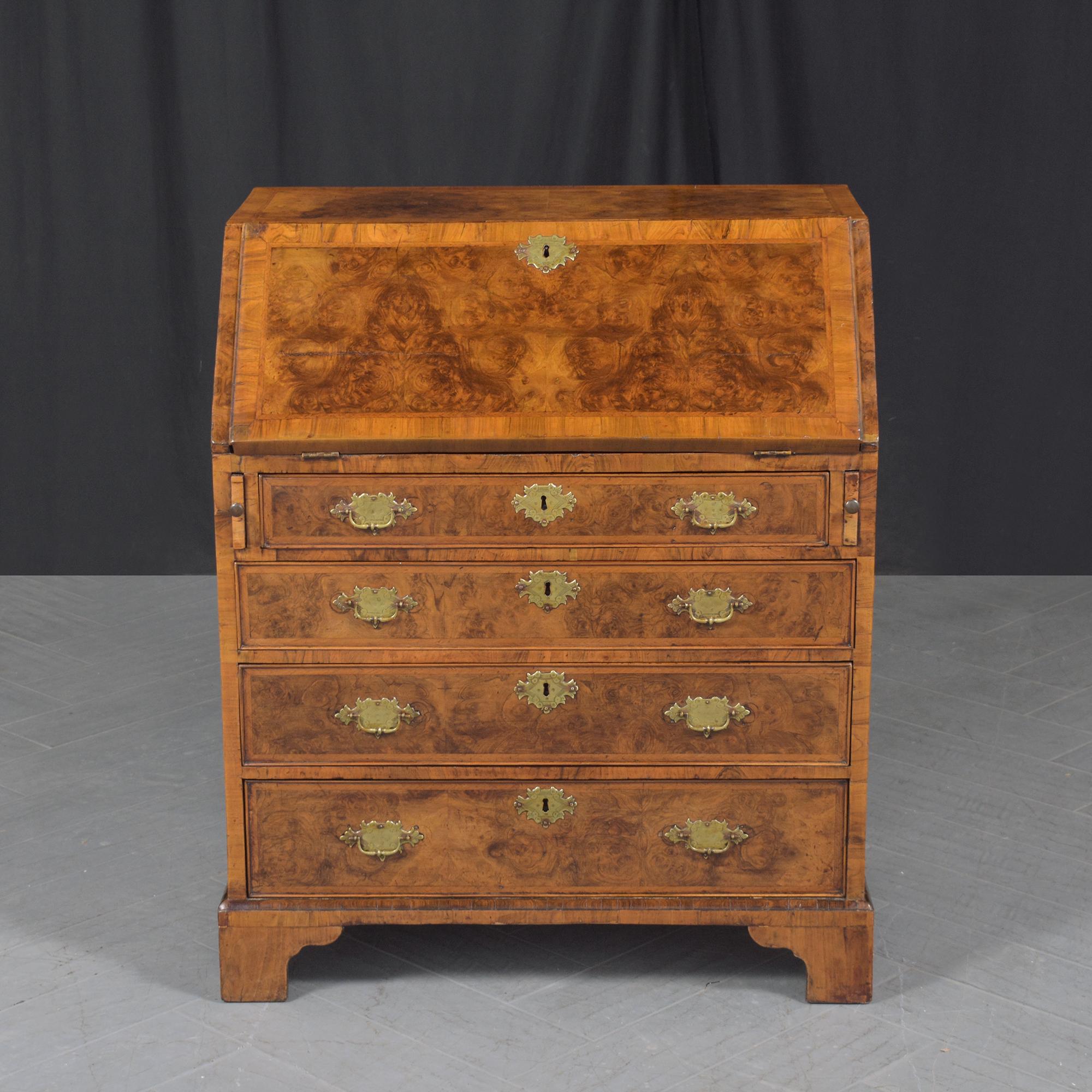 Explore the historic charm of our circa 1860s English George III Drop Front Desk, beautifully hand-crafted from a combination of walnut, brass, and inlay veneers. This piece has been completely restored by our professional in-house team of