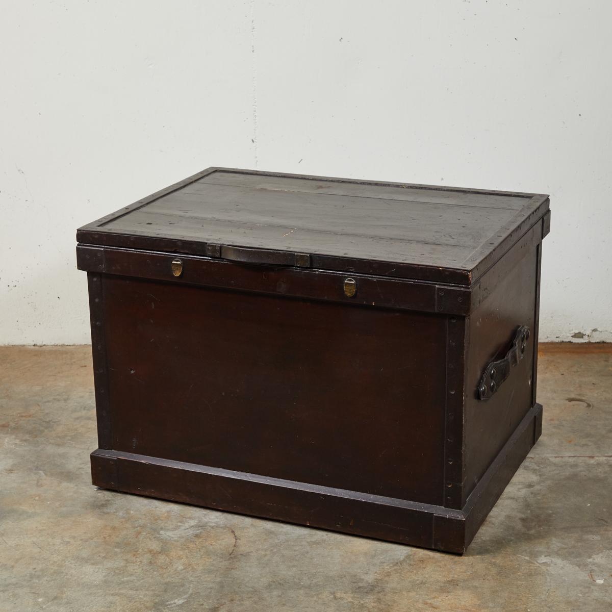 Large camphorwood silver chest from late 19th-century England. Stained to a deep, rich, mahogany shade, and featuring leather handles and studded iron siding, the chest has a sturdy, handsome feel. May be used as small coffee table or chest for
