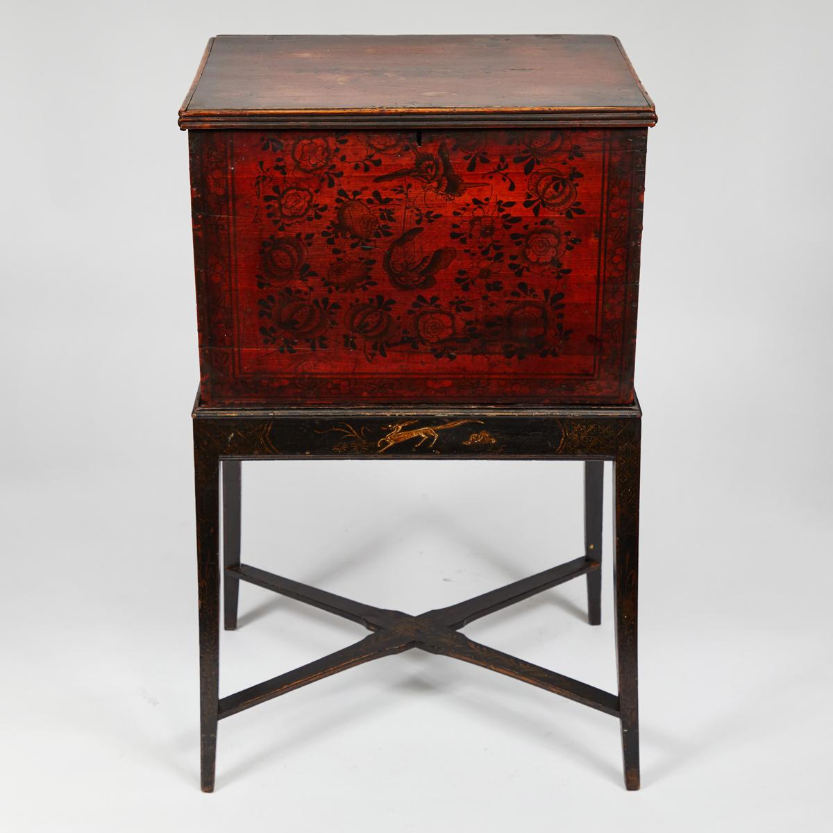 Late 19th-century English-imported tea box from China. Decorated with beautiful red and black hand-painted flora and fauna, and equipped with rectangular iron handles, the box is mounted on an ebonized wood base with handprinted decoration and a