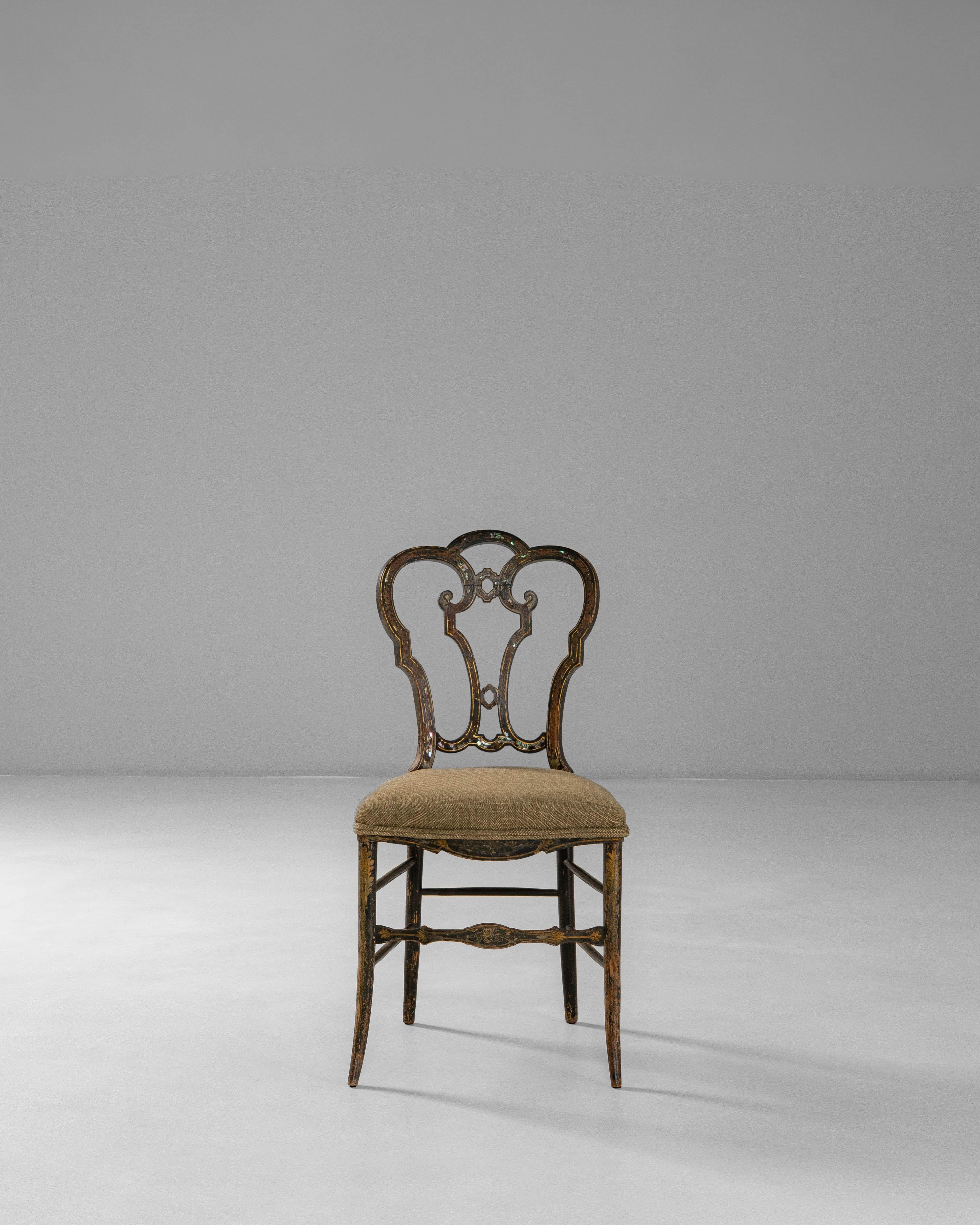 This 1860s French Baroque Revival wooden chair showcases the ornate craftsmanship and expressive detailing characteristic of the period. The sculptural backrest features an elegant interplay of curves and openwork carving, framed by hand-painted