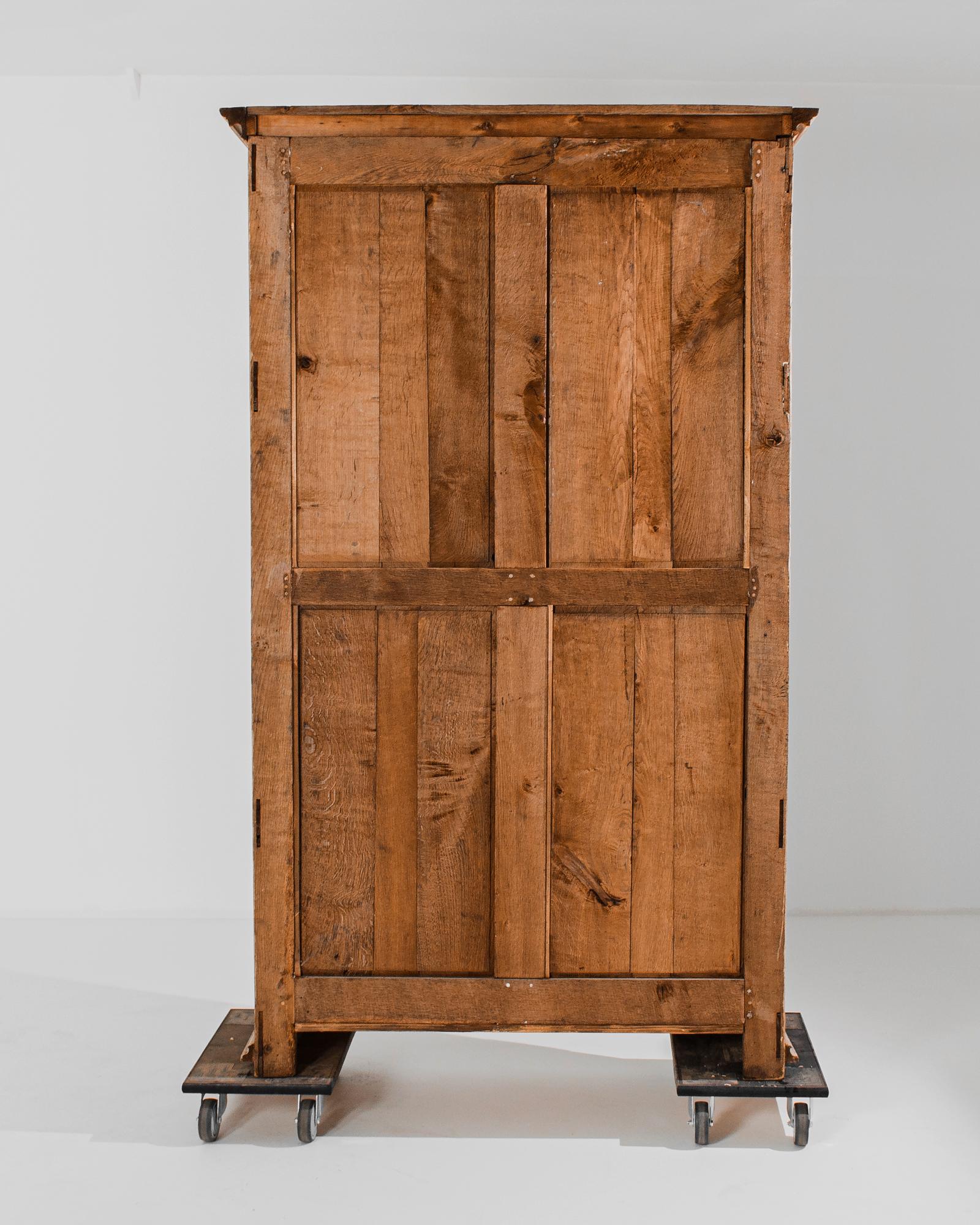 Step into the grandeur of the 1860s with a French Bleached Oak Armoire, a piece that marries elegance and craftsmanship. Crowned with regal molding at the top, this armoire stands tall as a testament to timeless design. The armoire doors are adorned