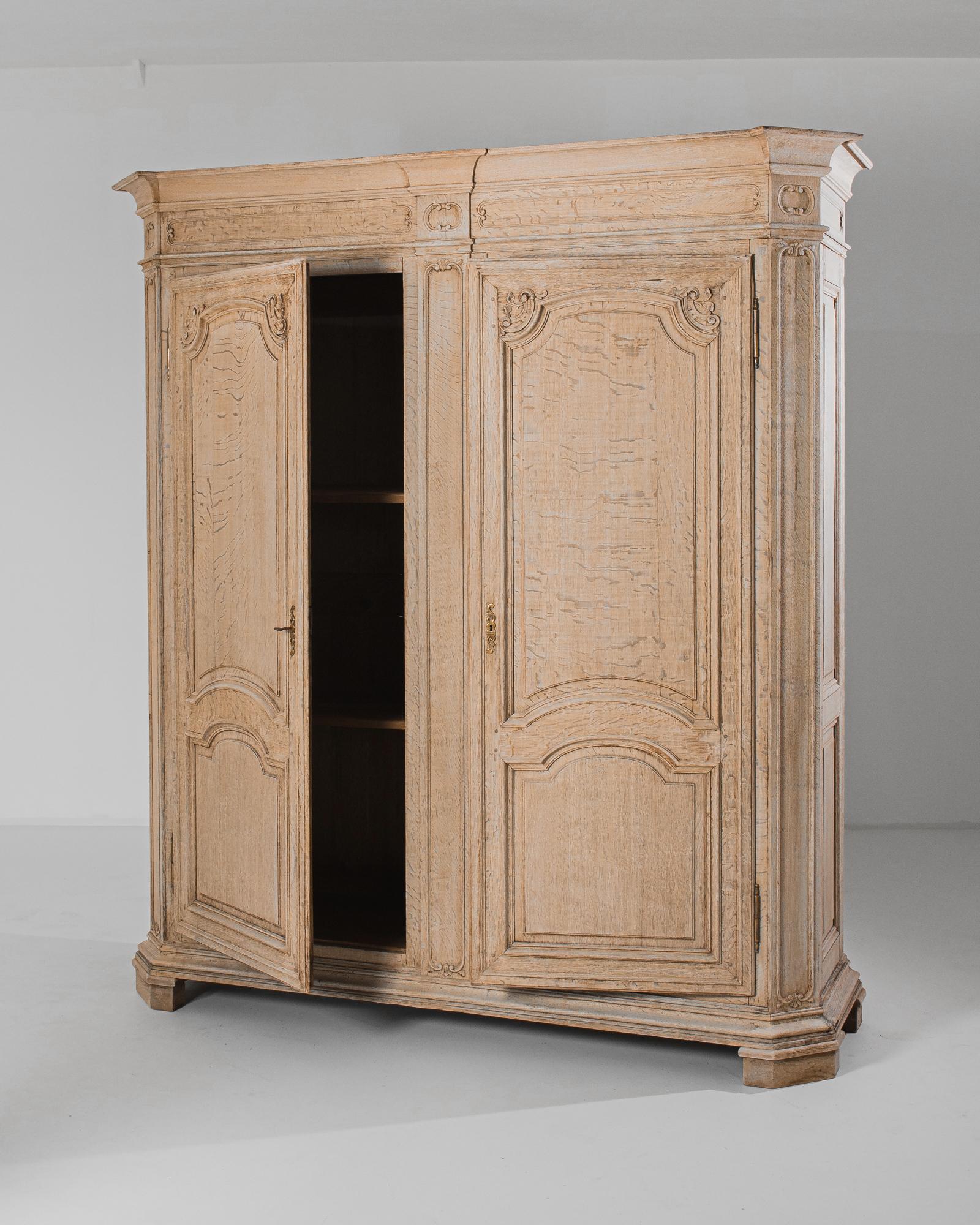 Stepping back into the opulent era of 19th-century France, this bleached oak armoire harks back to a time of grandeur and elegance. Crafted with meticulous attention to detail, this piece exemplifies the exquisite craftsmanship of French furniture