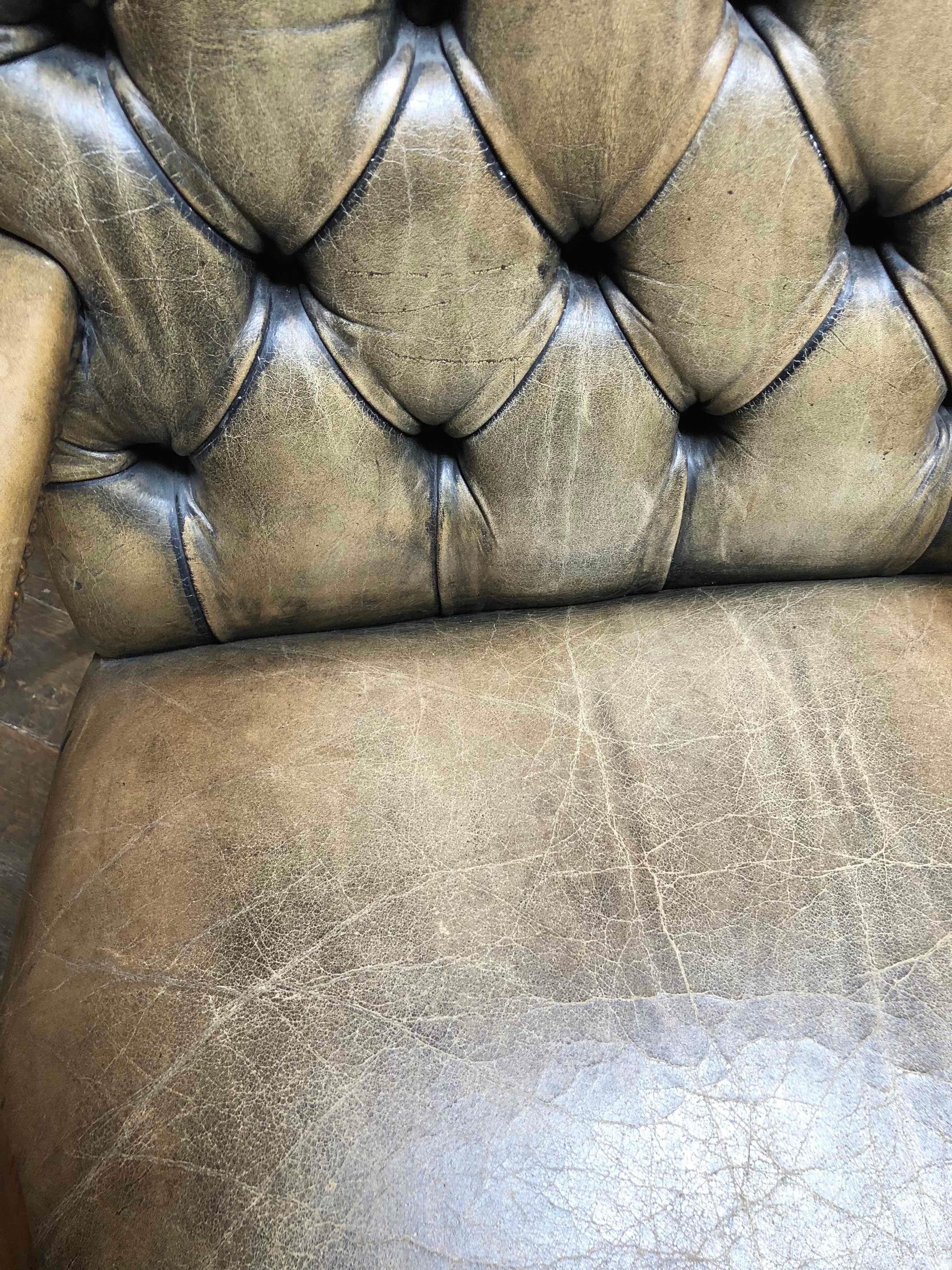 1860s Gainsborough light brown original leather upholstered tufted armchair. Wide chair with a high back, open sides, and short arms.