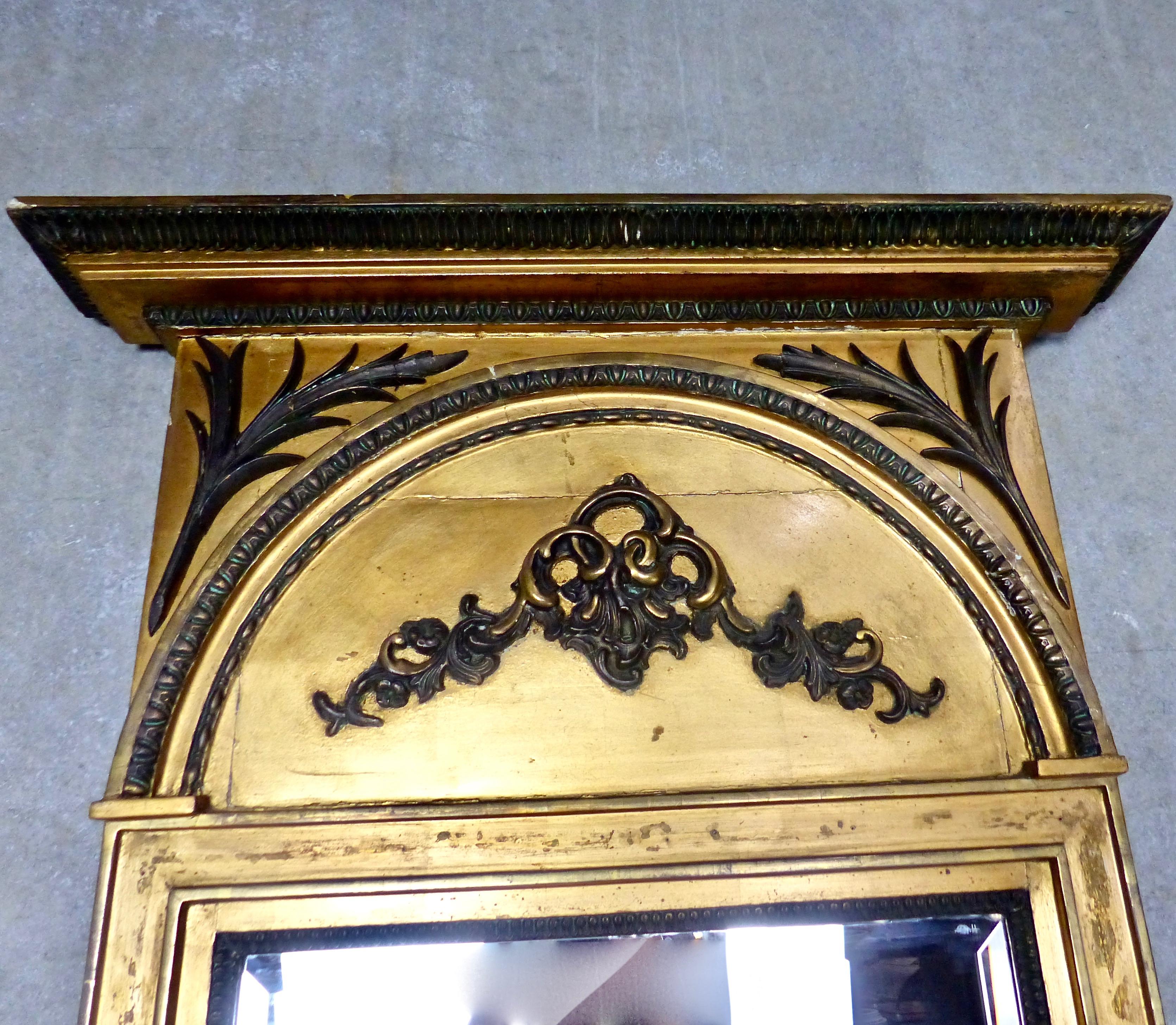 Well preserved giltwood mirror from circa 1860, Italy. Spectacular gold leaf coupled with contrasting cast iron applied details. Great size for hallway, mantel, or anywhere you need a hit of color and sparkle.
Dimensions: 60” H x 25” W x 2” D.
