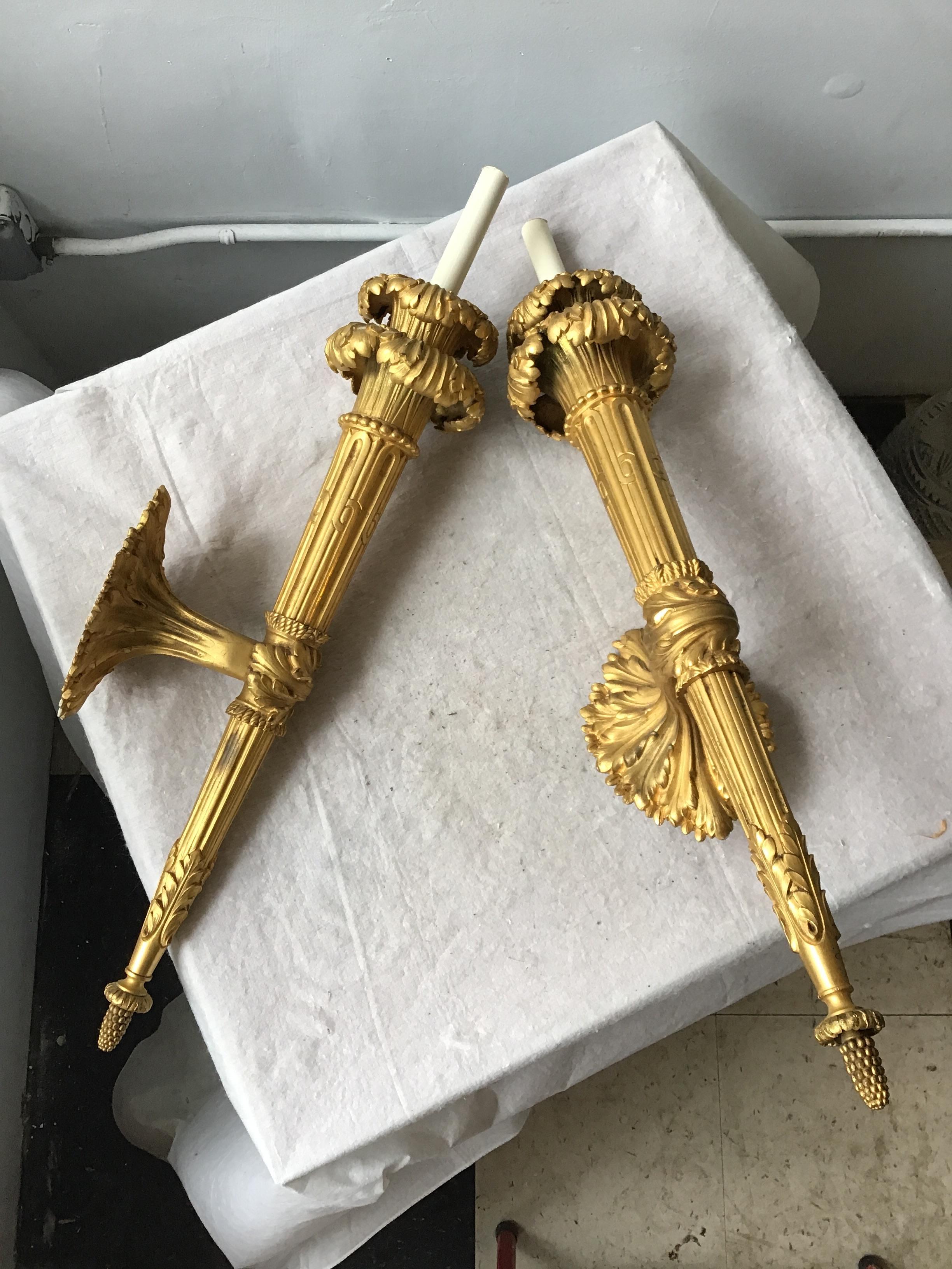1860s French gilt bronze torch sconces. High quality. I don’t think the glass shades are original. They don’t fit in tightly to the sconce. They wiggle a little if touched.