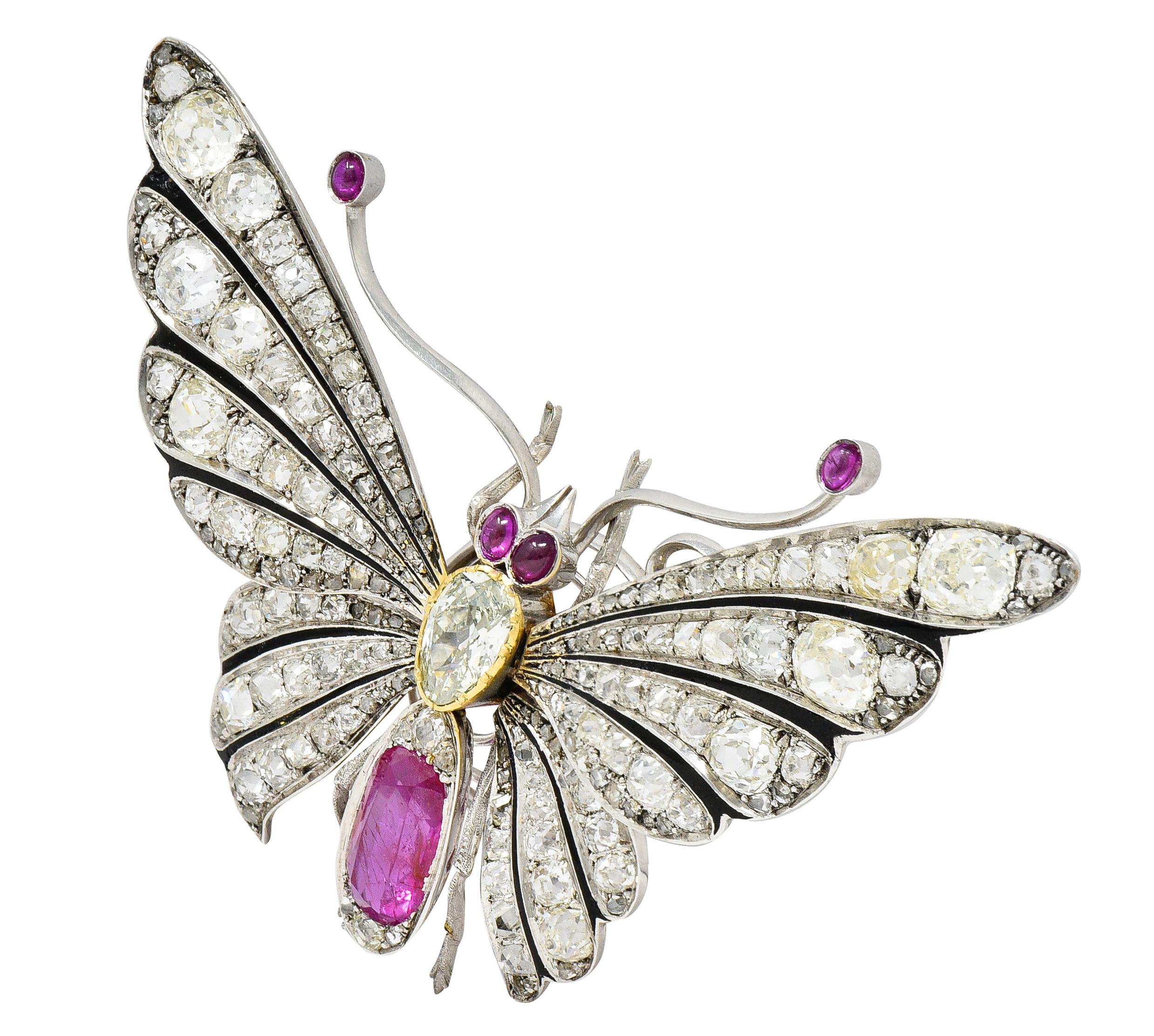 Brooch is designed as a substantial butterfly with spread wings and positioned on a coil for a 