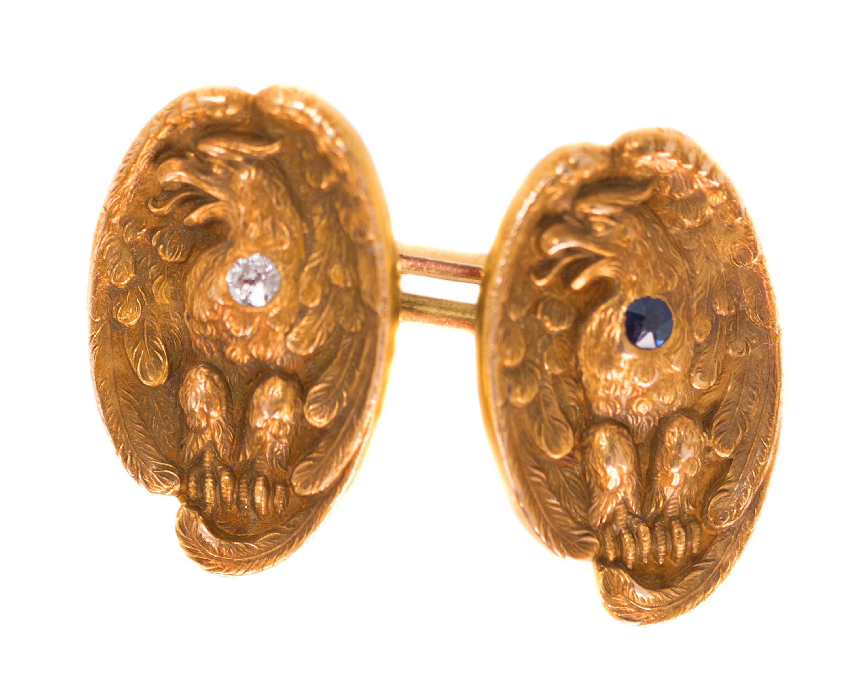 Antique Victorian Eagle Cufflinks - 14 Karat Yellow Gold, Diamonds, Sapphires

Features:
Chain Link Cufflinks
14 Karat Yellow Gold
Eagle image on each link with a gemstone set on the Eagle's chest
2 Blue Sapphires and 2 Old Mine Diamonds
Eagle wings