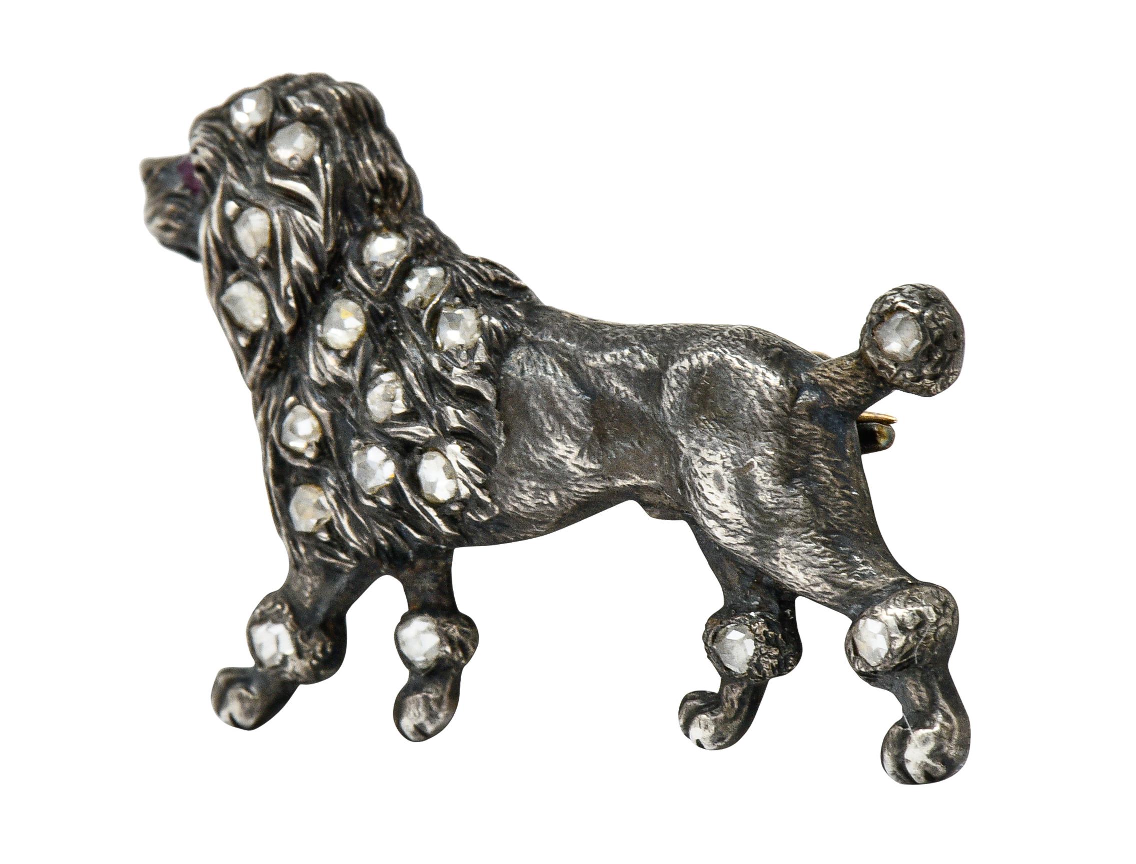 Brooch is designed as a proudly trotting poodle

With a highly rendered muscular body and finely textured fur

Accented by rose cut diamonds and a ruby eye; weighing in total approximately 0.30 carat

Completed by pin stem with closure

Tested as