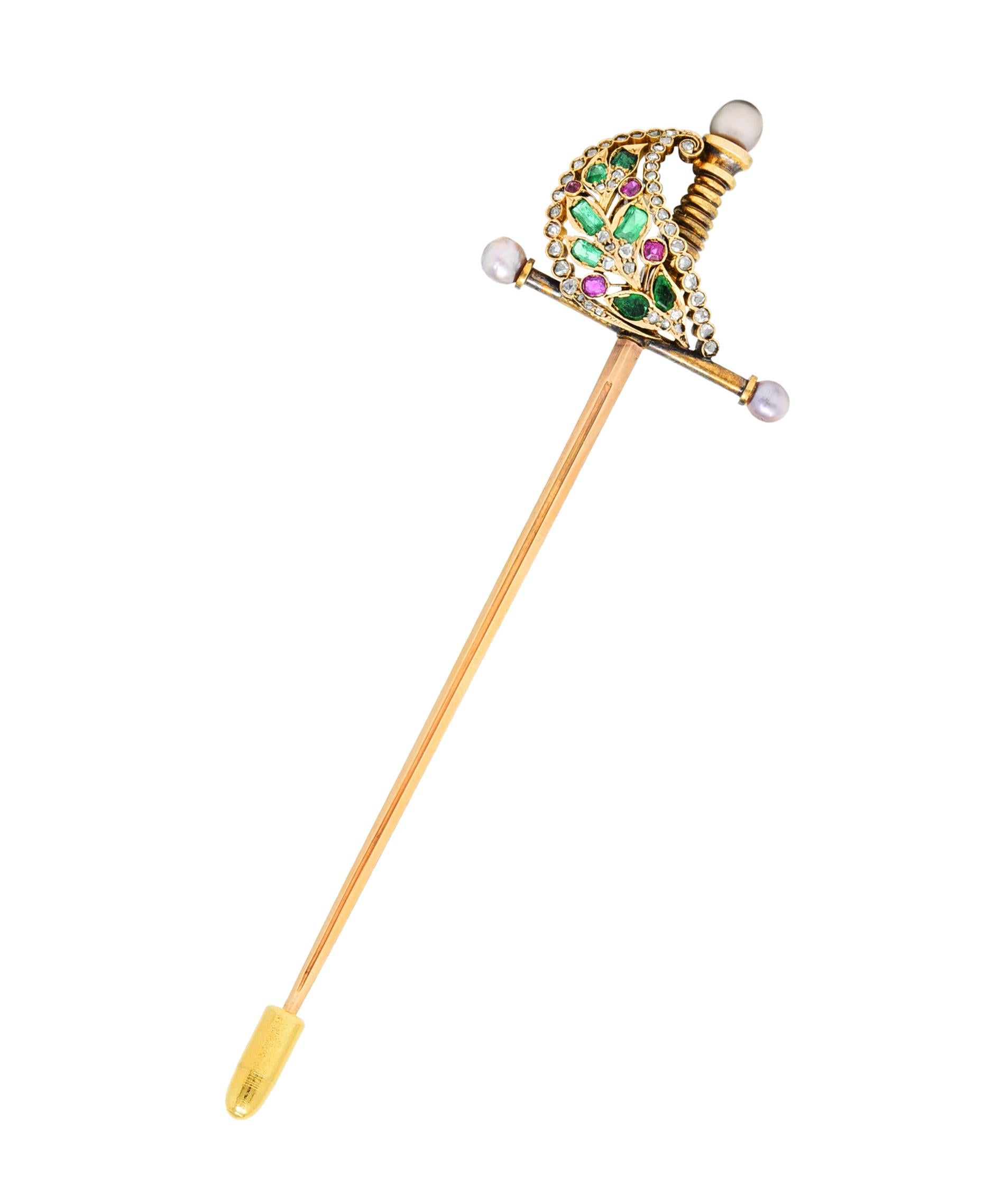 Designed as a sword with a decorative and gemmed hilt - tested as 18 karat gold

With rose cut diamonds, cushion cut rubies, and emeralds

Weighing in total approximately 1.25 carats

Hilt terminates as gray oval pearls - some with strong rosè