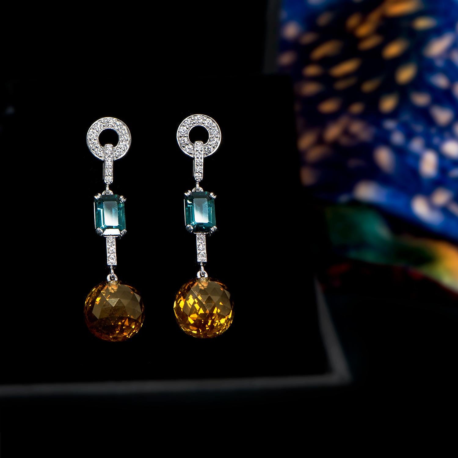 A beautiful pair of long drop earrings using Emerald Cut Blue Tourmalines with a total weight of 1.95 carat and citrine briolette balls (total weight of 18.61 carats) to stunning effect! An unforgettable combination of colours offset by white