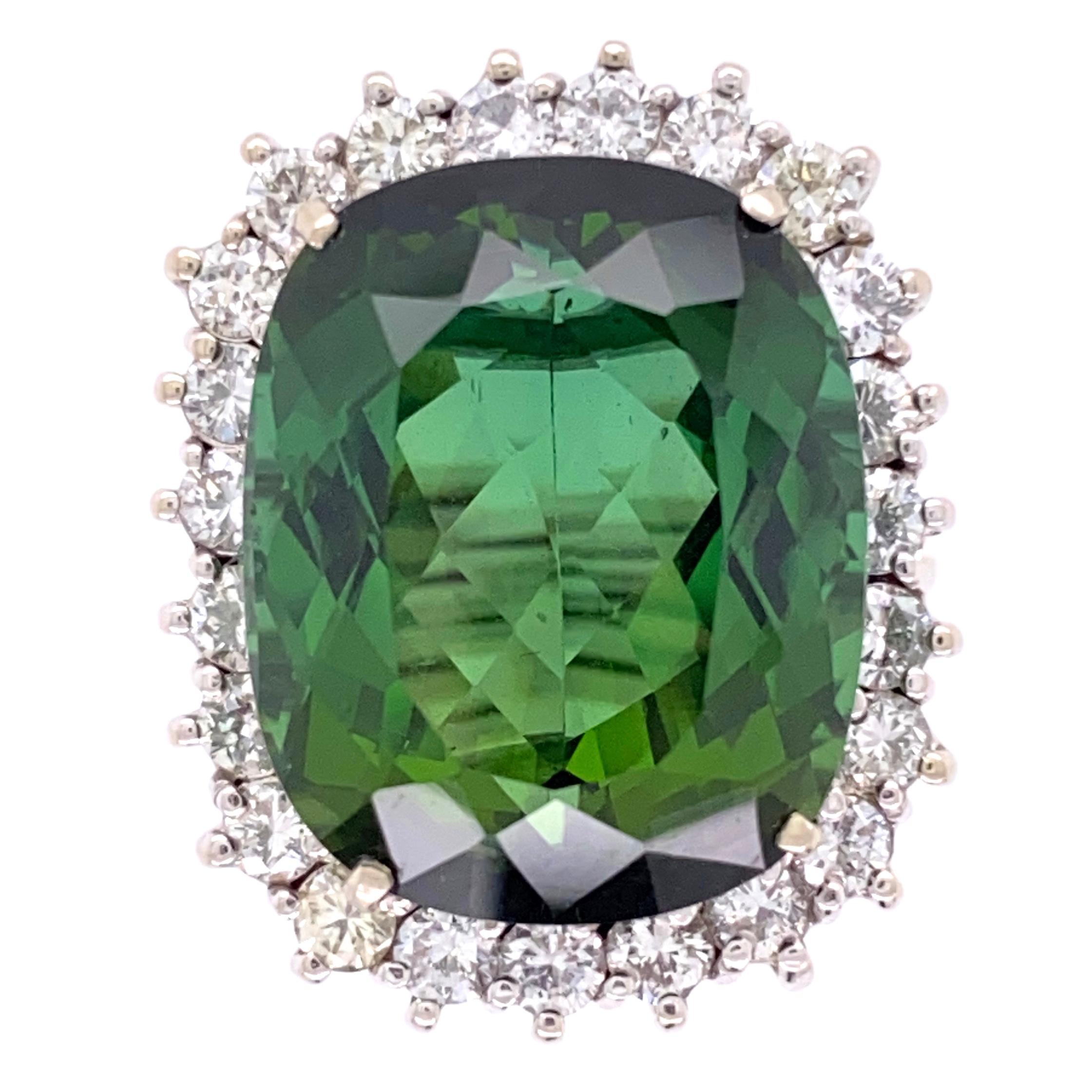 Simply Beautiful! Finely detailed Mid Century Modern Green Tourmaline and Diamond Cocktail Solitaire Ring. Centering a Hand set securely nestled 18.63 Carat Green Tourmaline, surrounded by Diamonds, approx. 1.70tcw. Hand crafted in 18K White Gold.