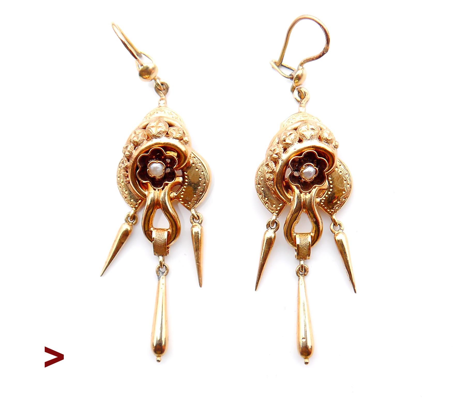 A pair of antique earrings with delicate three tiers bodies decorated with seed pearls and engraved ornaments.

Freely suspended drop shaped dangles make this design complete.

Swedish hallmarks on both, marked 18K Gold.

Worn / scratched but still